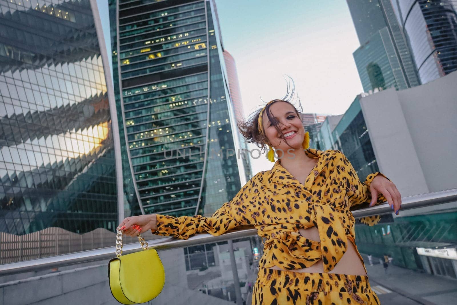 A beautiful shot of woman in yellow smiling and the Moscow City in the background by A_Karim