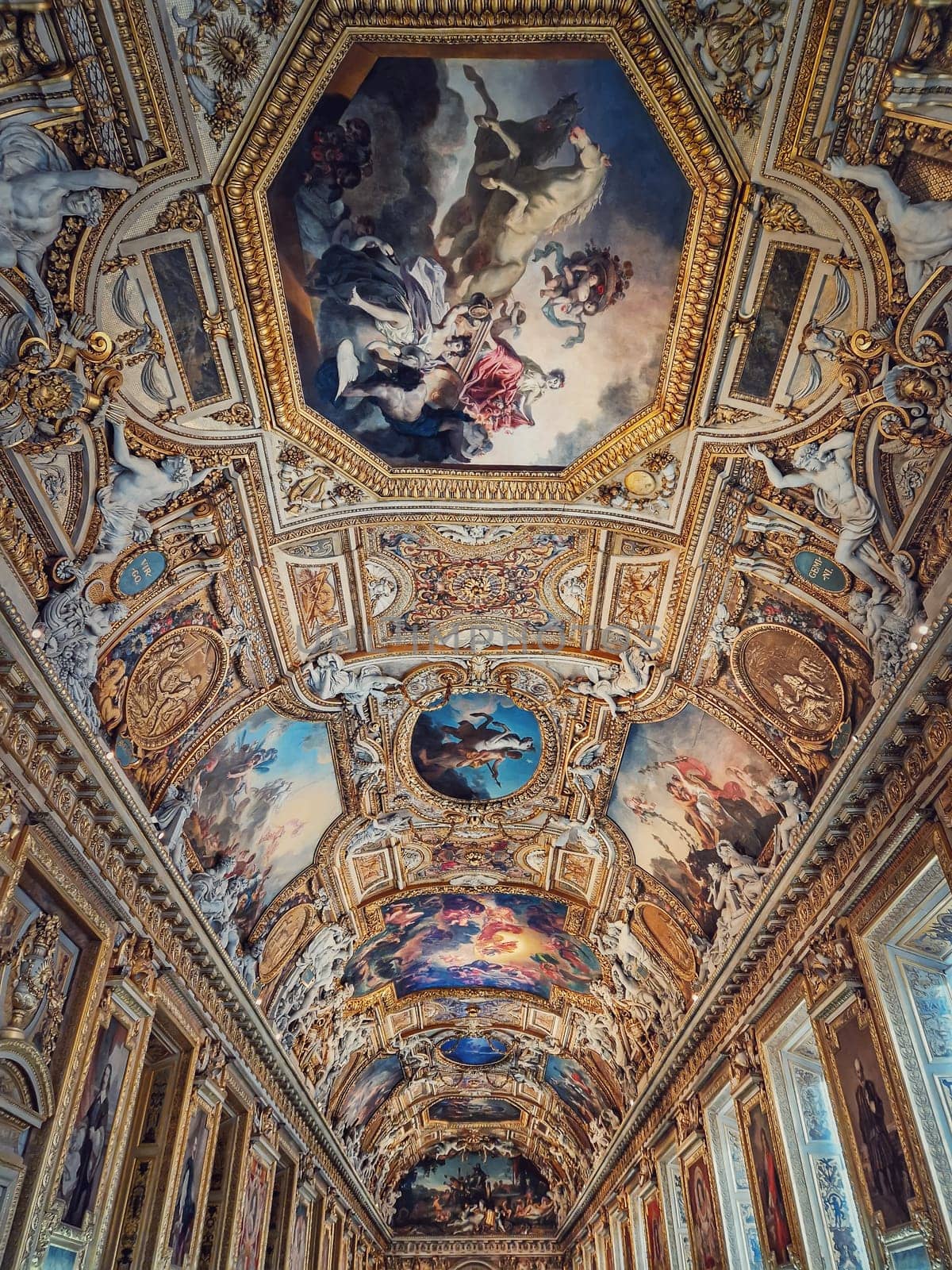 The Galerie d'Apollon a large and iconic room of the Louvre museum. Apollon gallery is a gold decorated hall with zodiac signs ornaments and murals on the walls and ceiling. Architectural masterpiece by psychoshadow