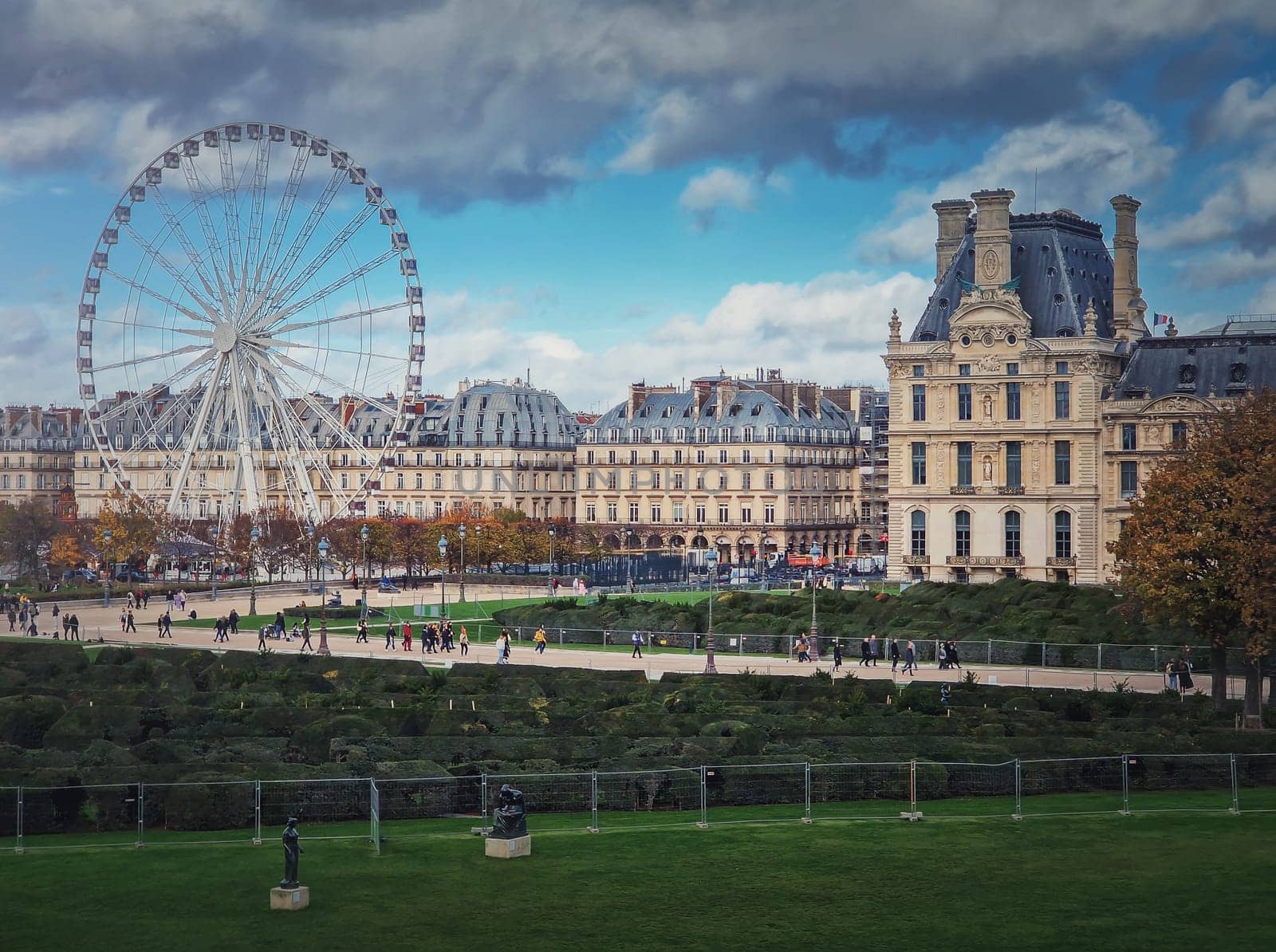 Cityscape view to the Grande Roue de Paris ferris wheel next to Louvre museum building and parisian houses, France by psychoshadow