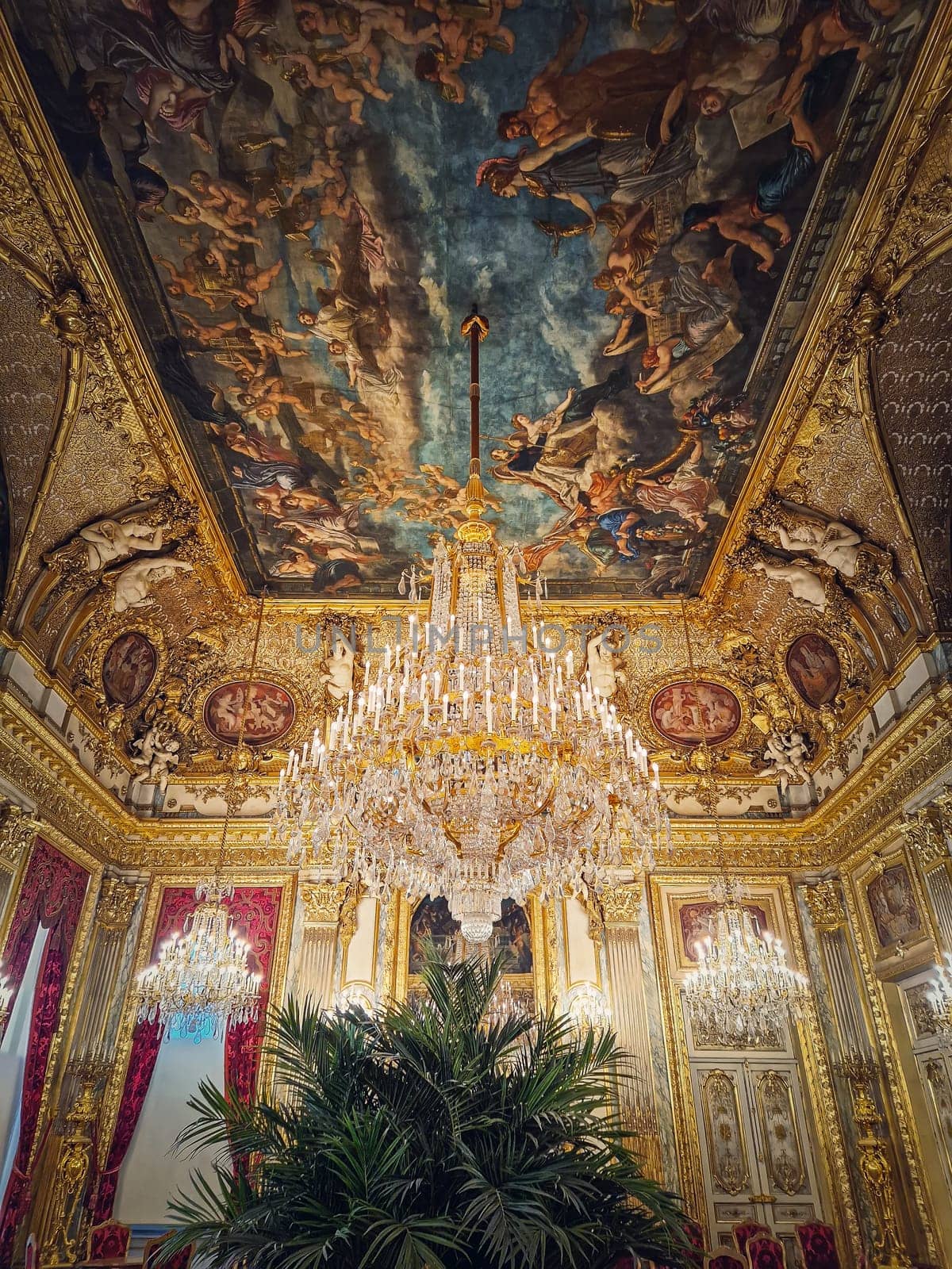 Beautiful decorated Napoleon apartments at Louvre palace. Royal family rooms with cardinal red curtains, golden ornate walls, paintings and crystal chandeliers suspended from ceiling by psychoshadow