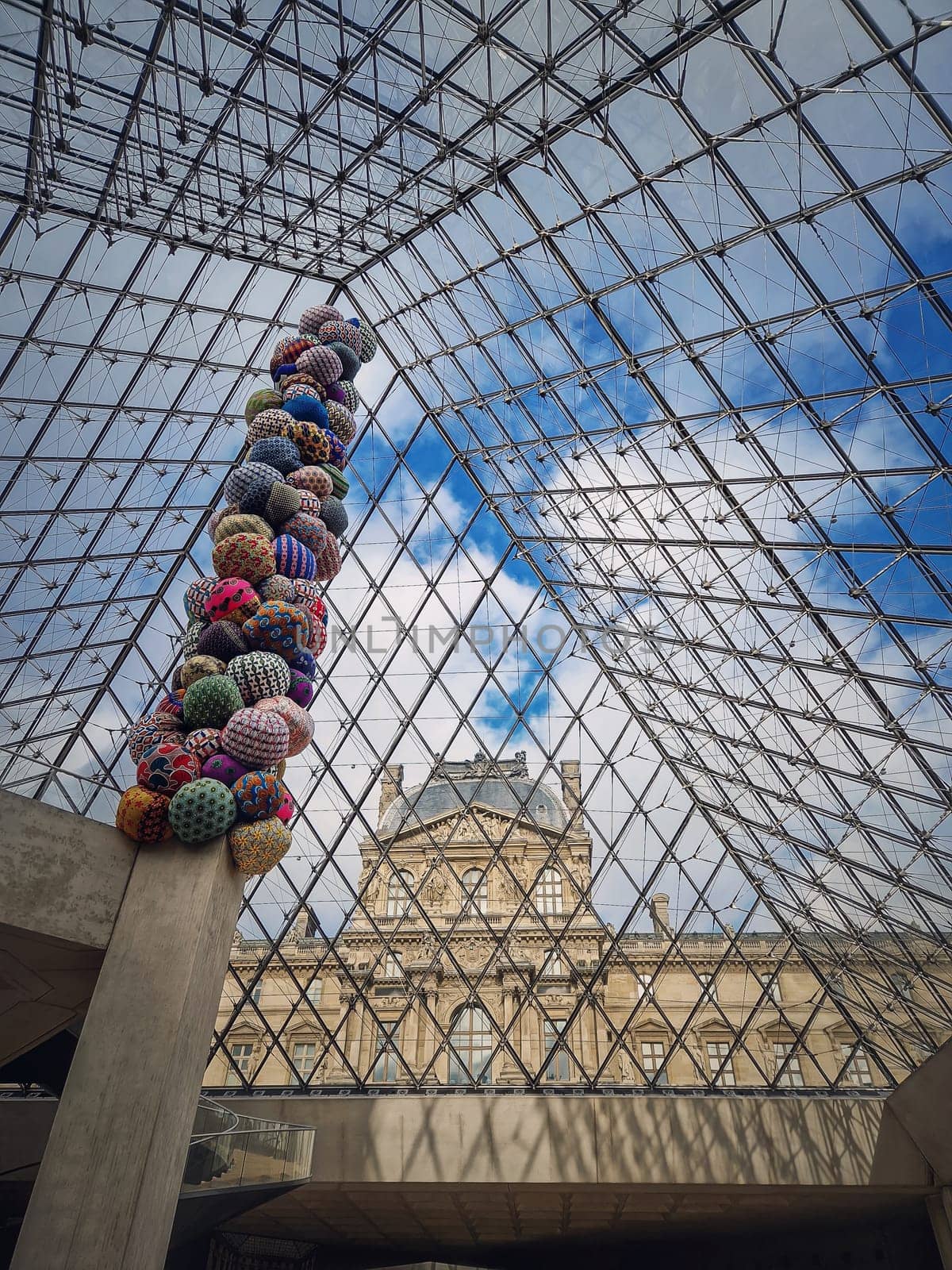 Underneath the Louvre glass pyramid, vertical background. Beautiful architecture details with an abstract mixture of classical and modern styles