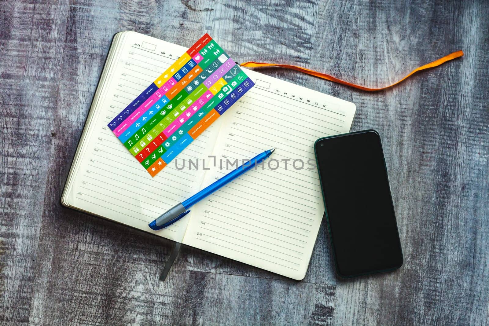 Dairy on the table with phone pen stickers in grey tone