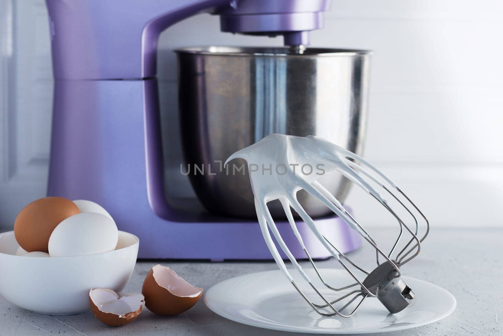 Modern mixer on the kitchen table with eggs and whipped meringue. by lara29