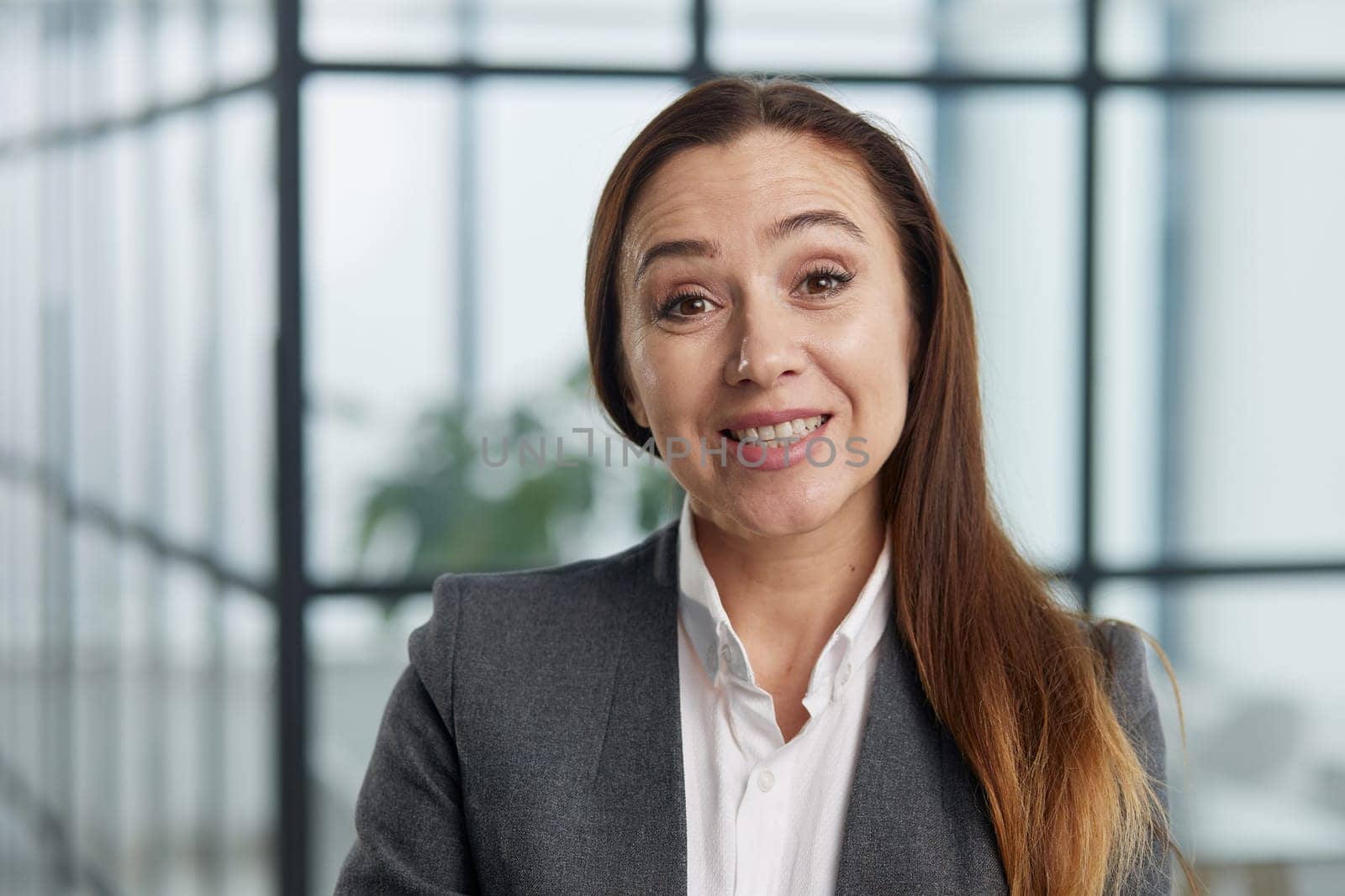 Confident business woman with arms crossed smiling at camera