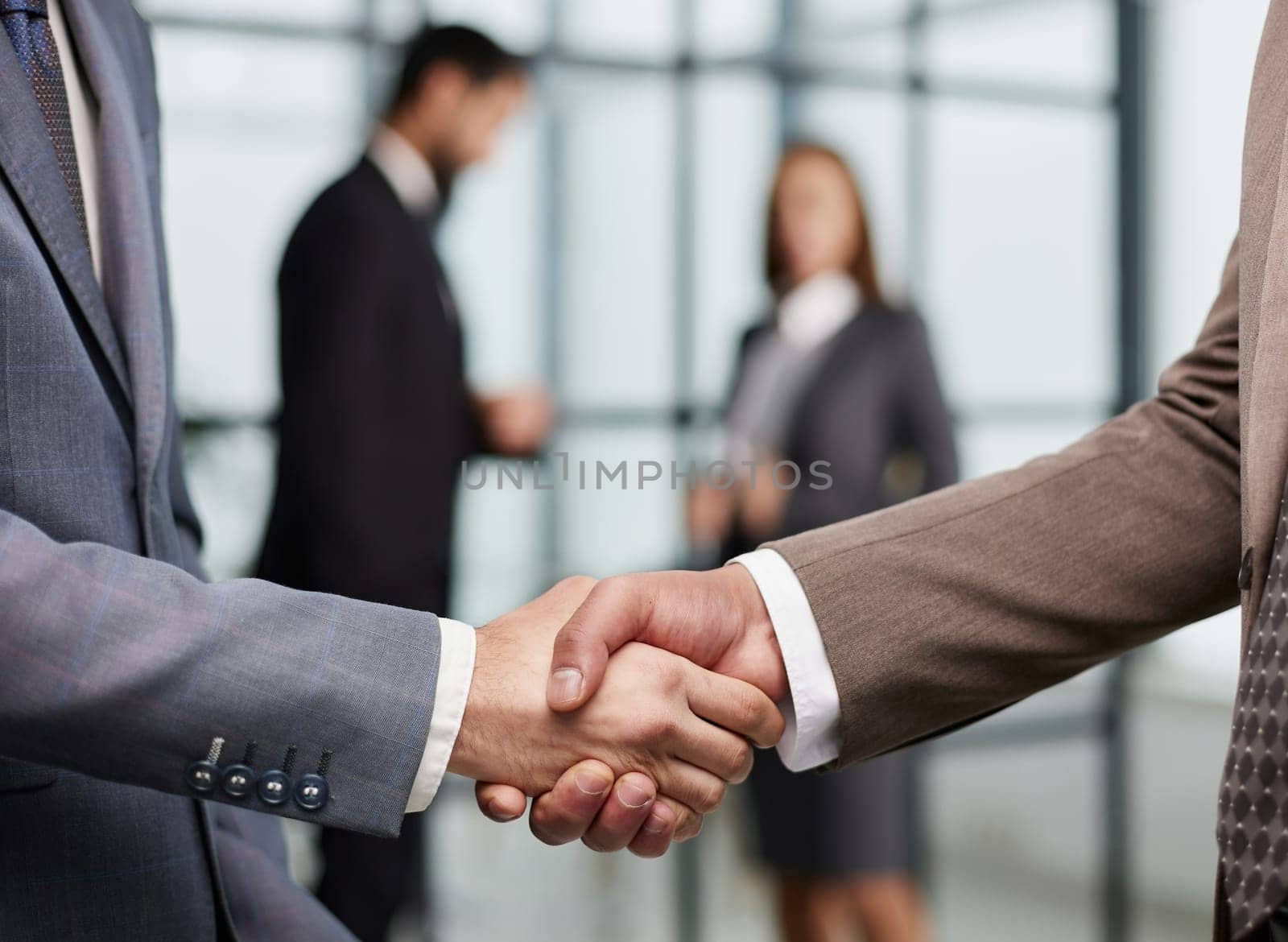 Nice to meet you. Close-up of two young businessmen shaking hands