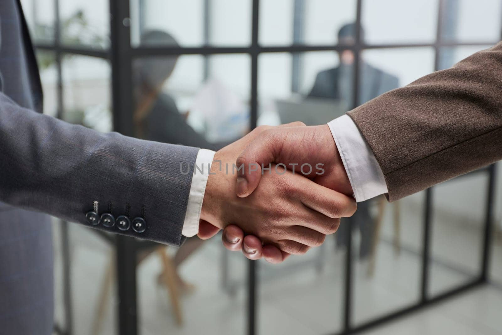 Nice to meet you. Close-up of two young businessmen shaking hands