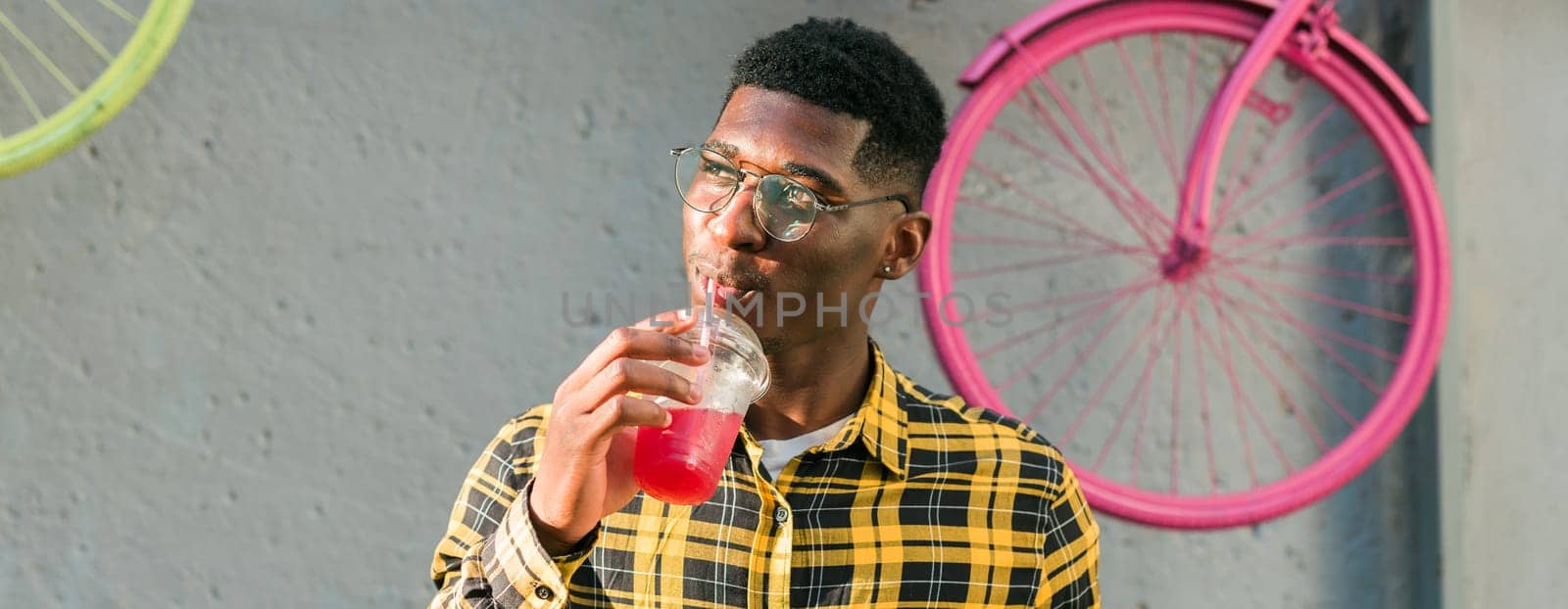 Banner young cheerful african american male on city having fun and holding cocktail copy space. Man on summer holiday. Leisure lifestyle holiday and summer drinks concept by Satura86