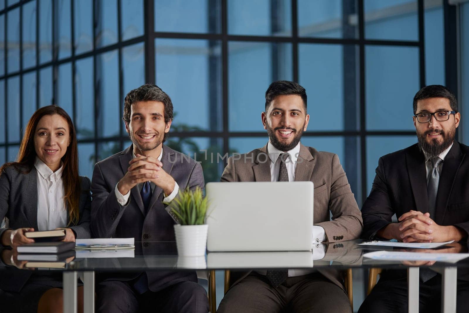 Serious manager at a table with his team during a meeting