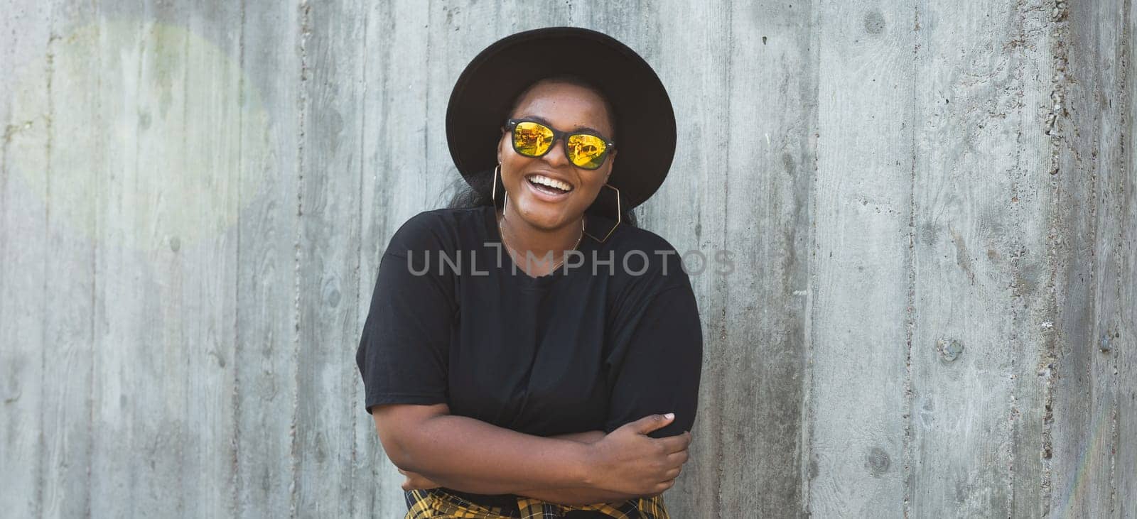 Banner portrait stylish young African American girl with curly hair in fashionable sunglasses in urban with copy space and place for advertising - summer hipster photos with instagram style by Satura86