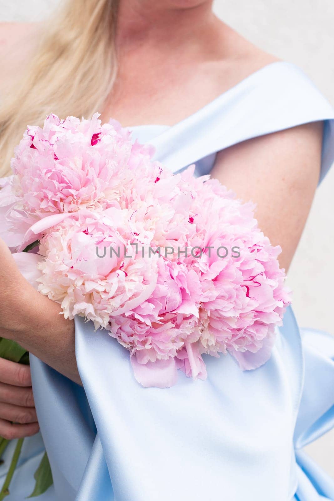 bride in a blue wedding dress with a bouquet of pink peonies, pastel paradise, floral background, complementary color combination. High quality photo