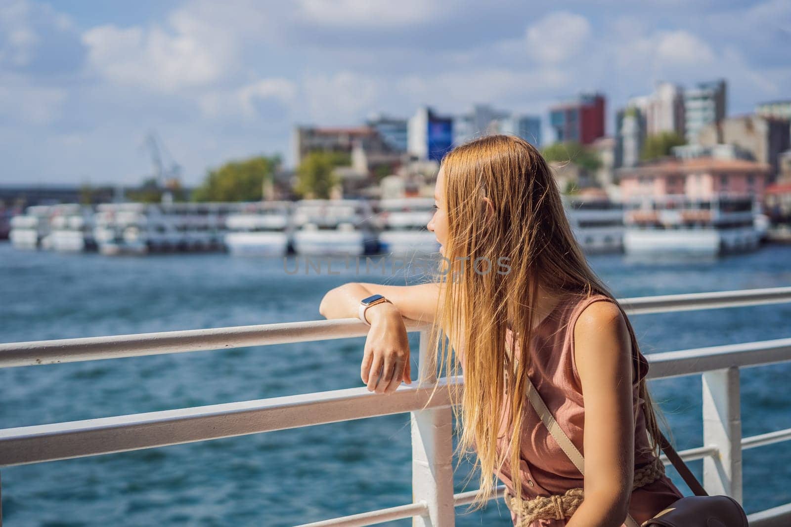Happy woman enjoying the sea from ferry boat crossing Bosphorus in Istanbul. Summer trip to Istanbul.