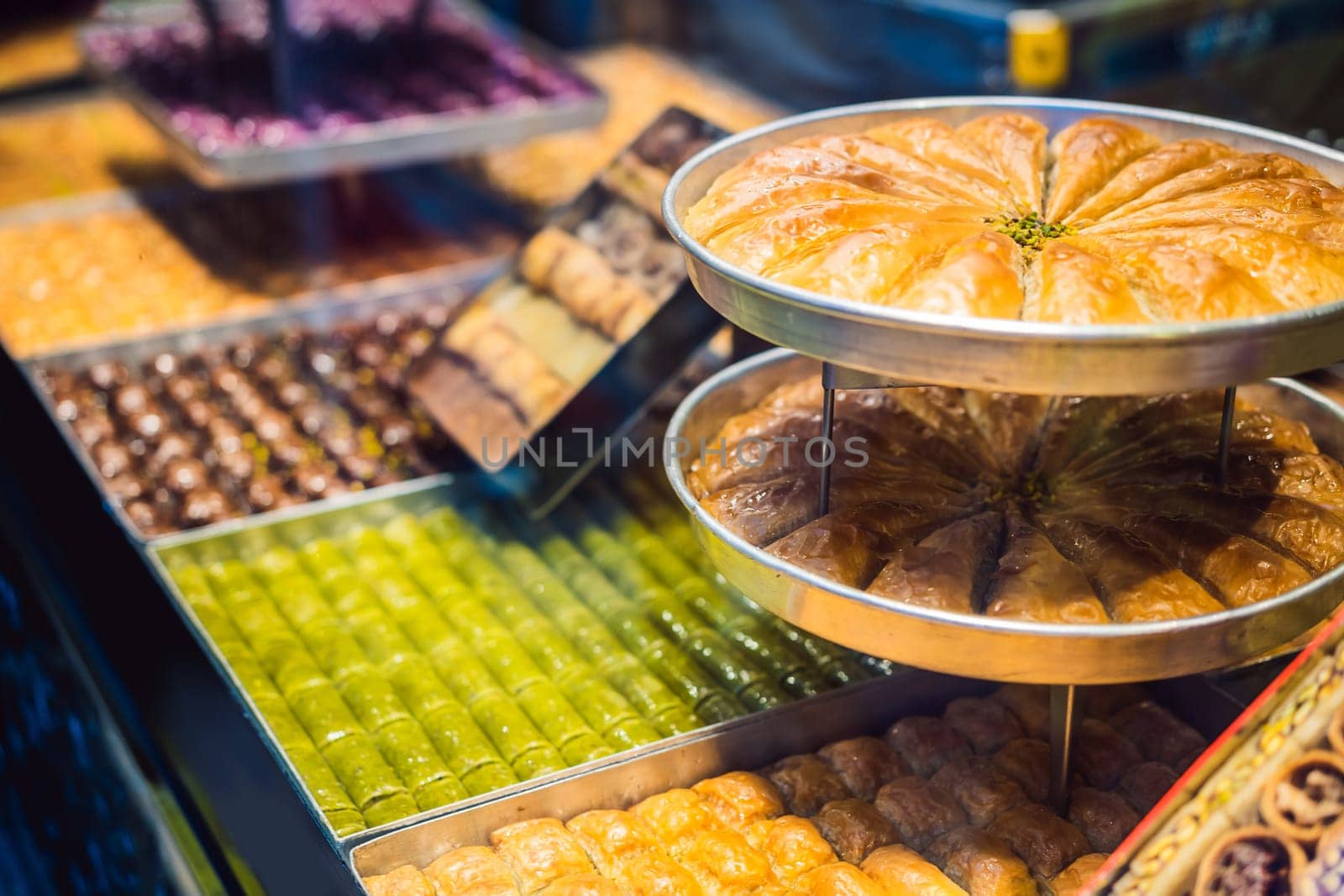 Traditional oriental sweet pastry cookies, nuts, dried fruits, pastilles, marmalade, Turkish desert with sugar, honey and pistachio, in display at a street food market.