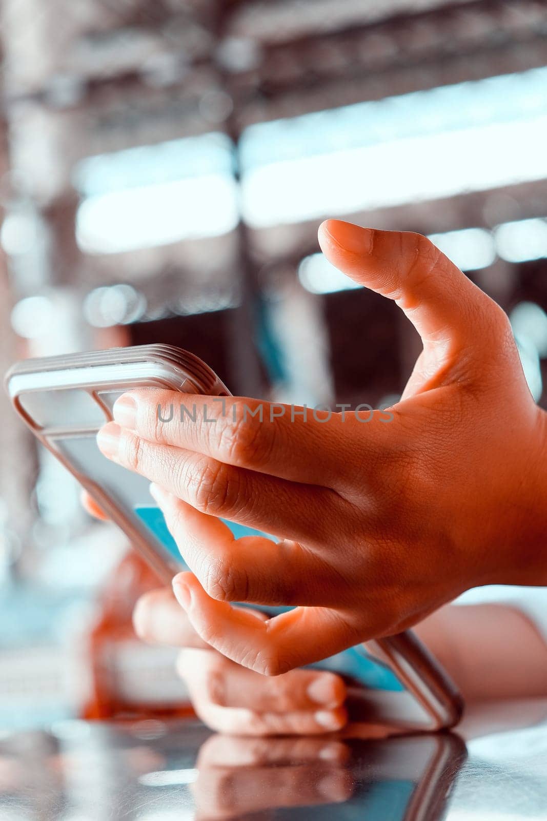 Close up shot of a woman using a mobile phone in a cafe by ponsulak