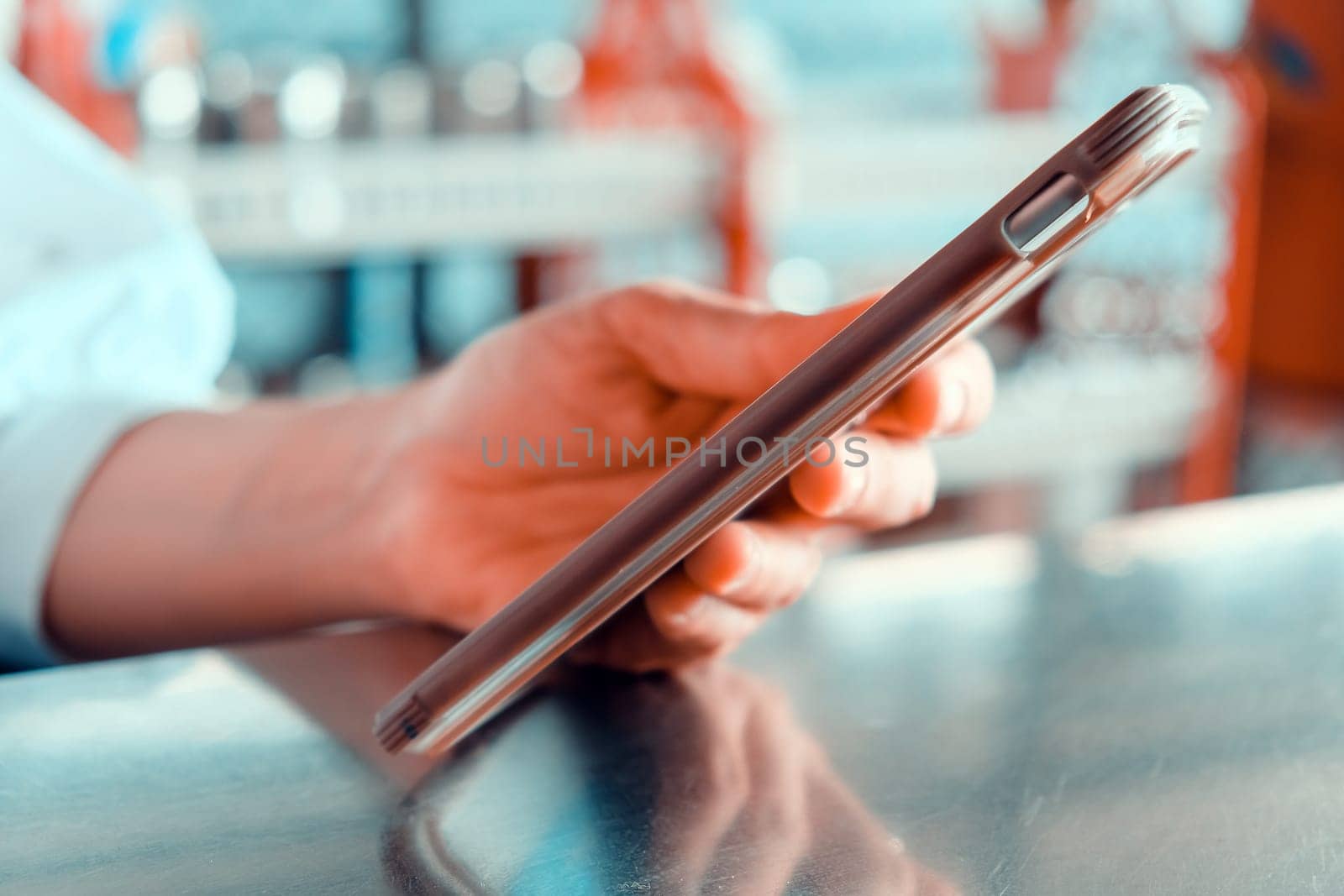Close up shot of a woman using a mobile phone in a cafe