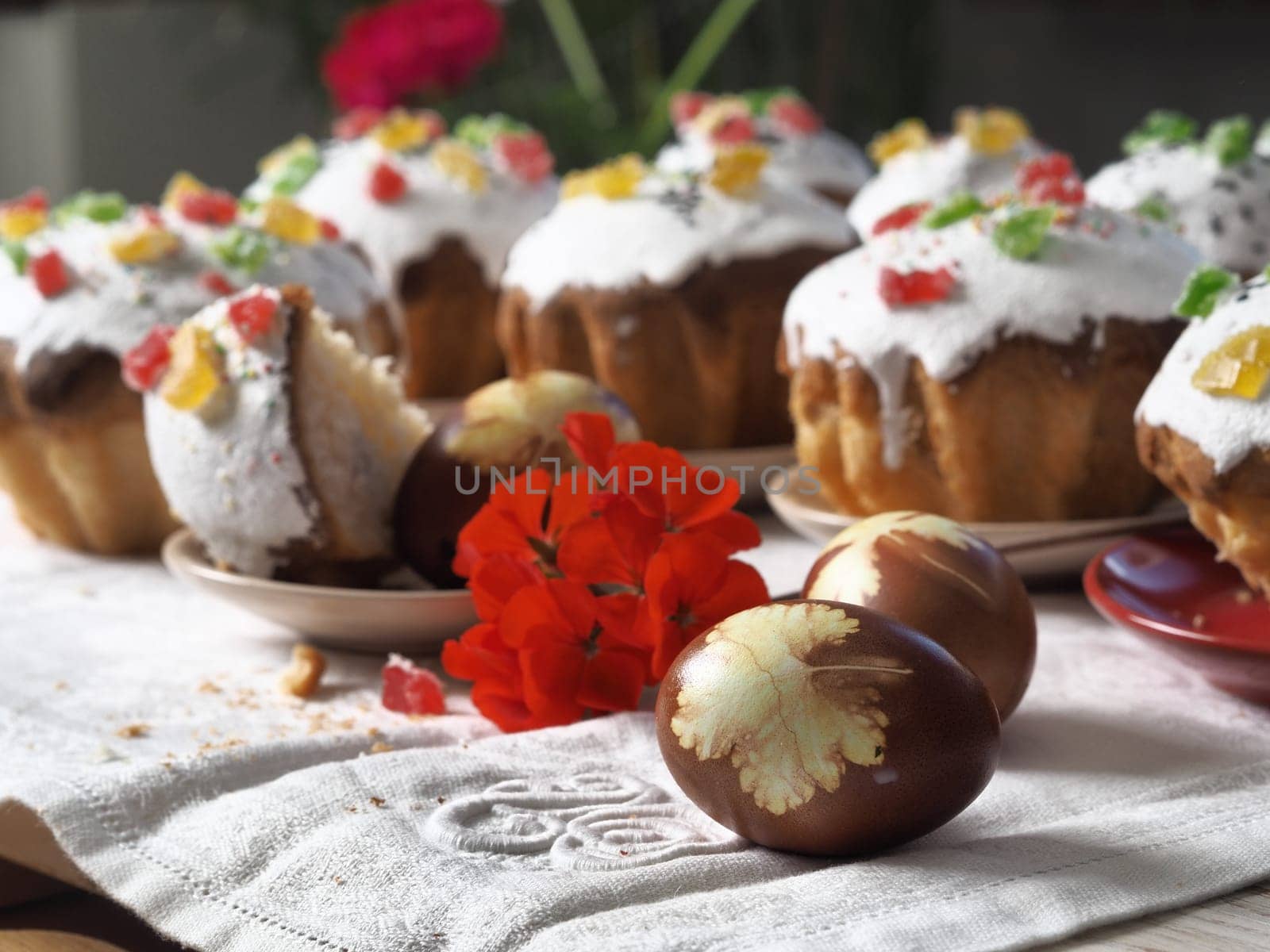 Homemade natural delicious Easter pastries with eggs are laid out on a white tablecloth. by TatianaPink