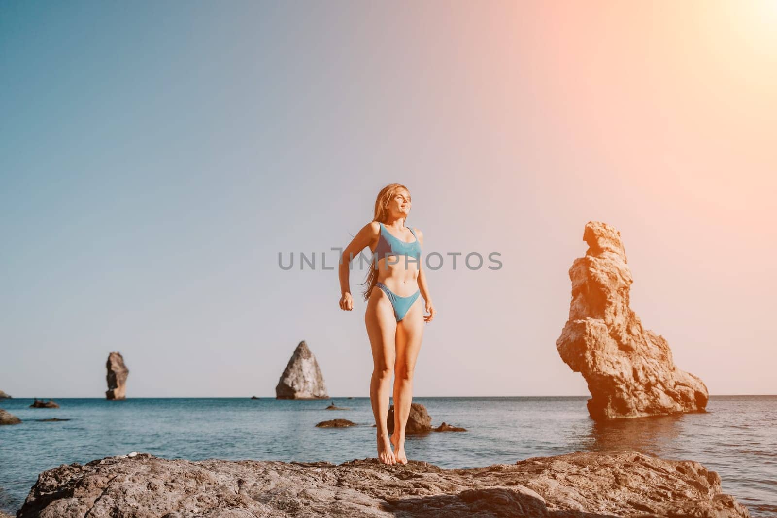 Woman sea pilates. Sporty happy middle aged woman practicing fitness on beach near sea, smiling active female training on yoga mat outside, enjoying healthy lifestyle, harmony and meditation. by panophotograph