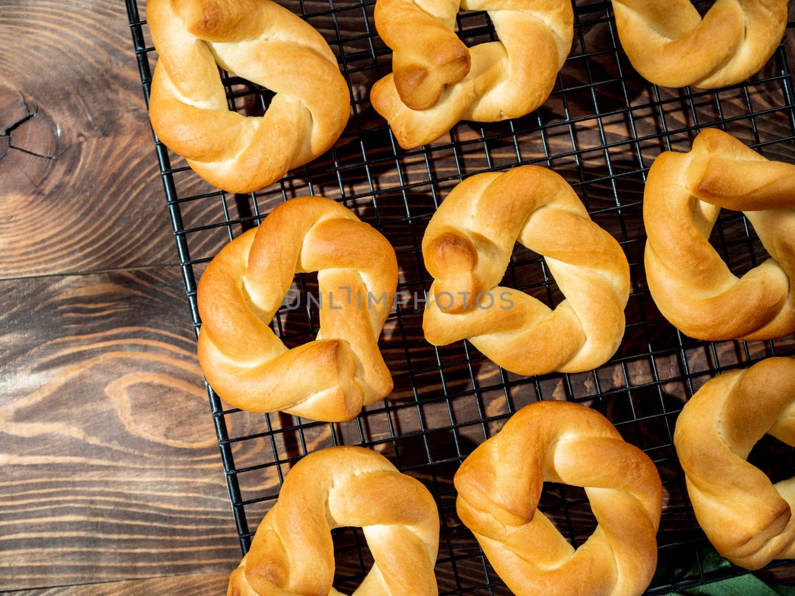 Taralli twist on wooden background. Typical italian ring-shaped or doughnut-shaped biscuit cookies or appetizers for wine Taralli or Taralle. Top view or flat lay. Copy space
