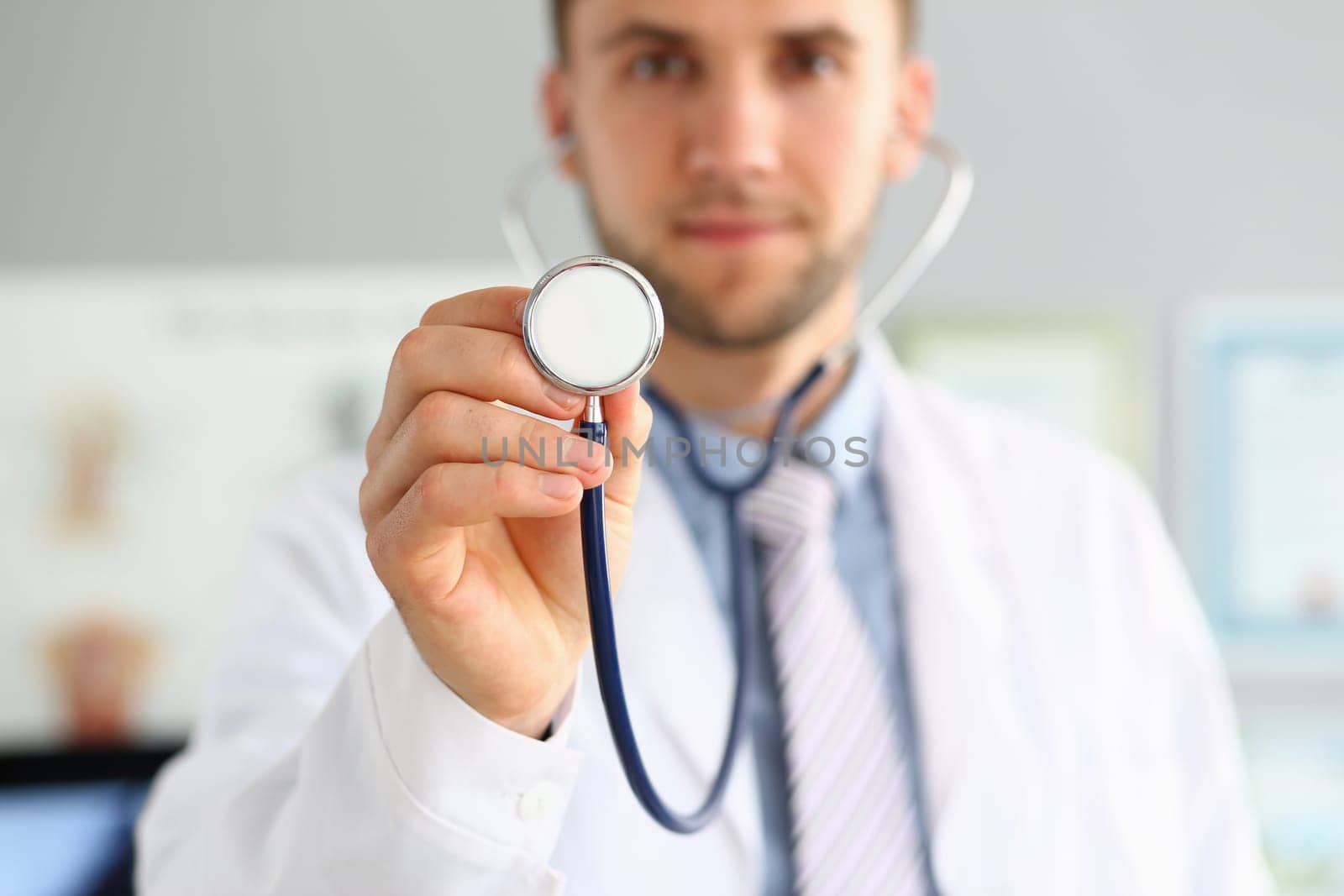 Doctor holds stethoscope in hands and provides medical services. Medical insurance and treatment of cardiac diseases