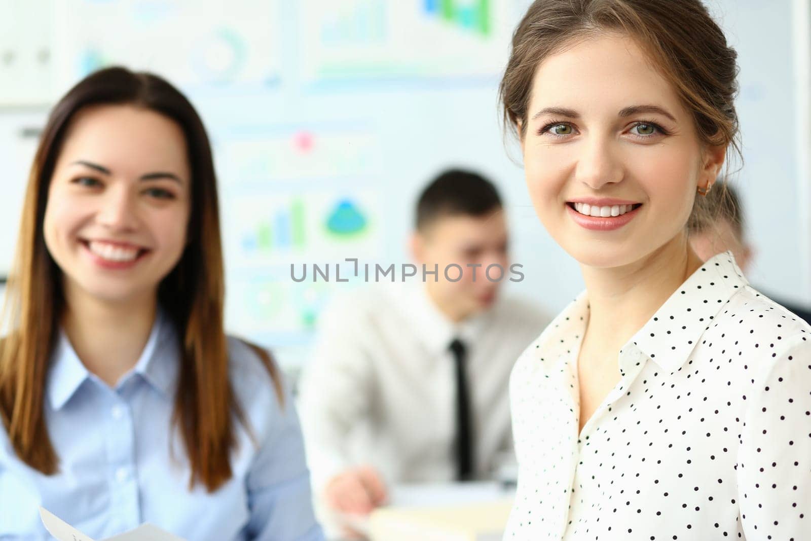Business woman with staff and a group of people in background in modern office by kuprevich
