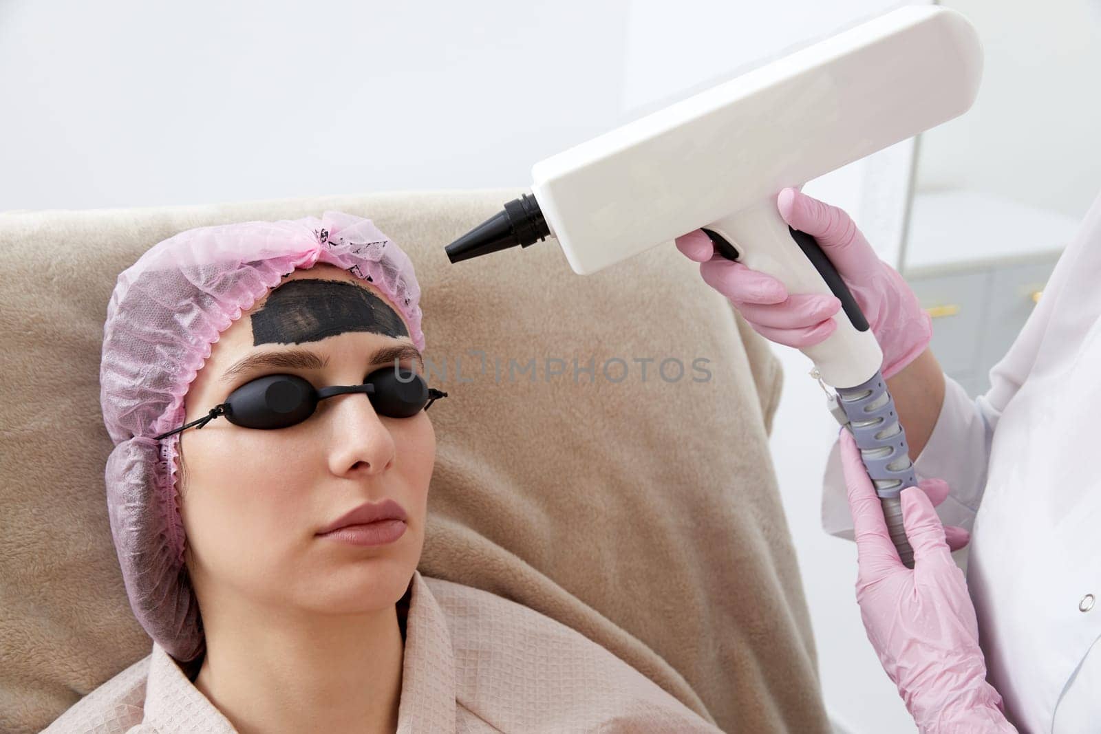 Woman getting carbon peeling in beauty salon by Mariakray
