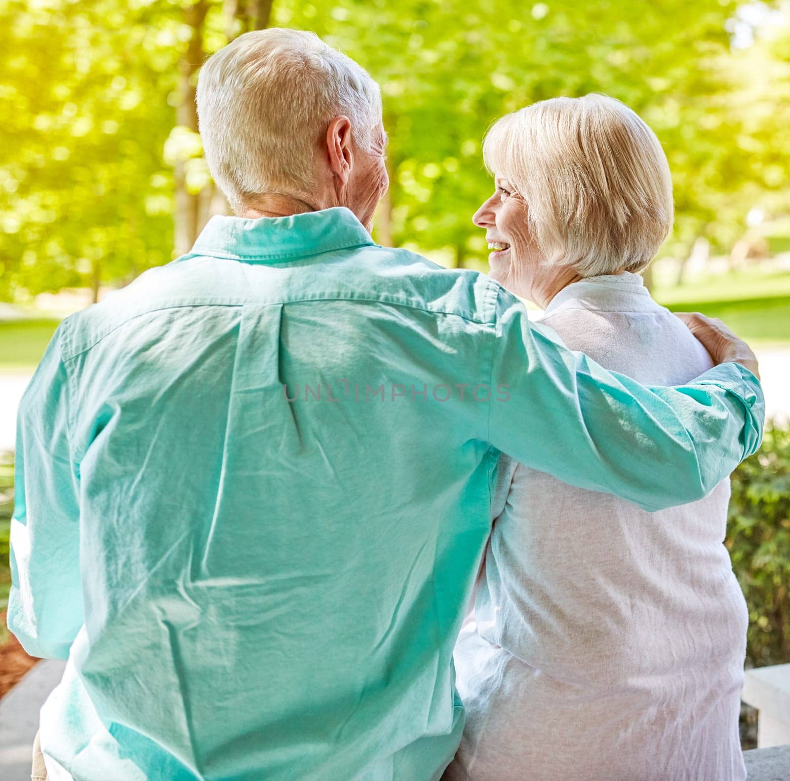 I love summer days with you. Rearview shot of an affectionate senior couple sitting outside on their porch during the summer. by YuriArcurs