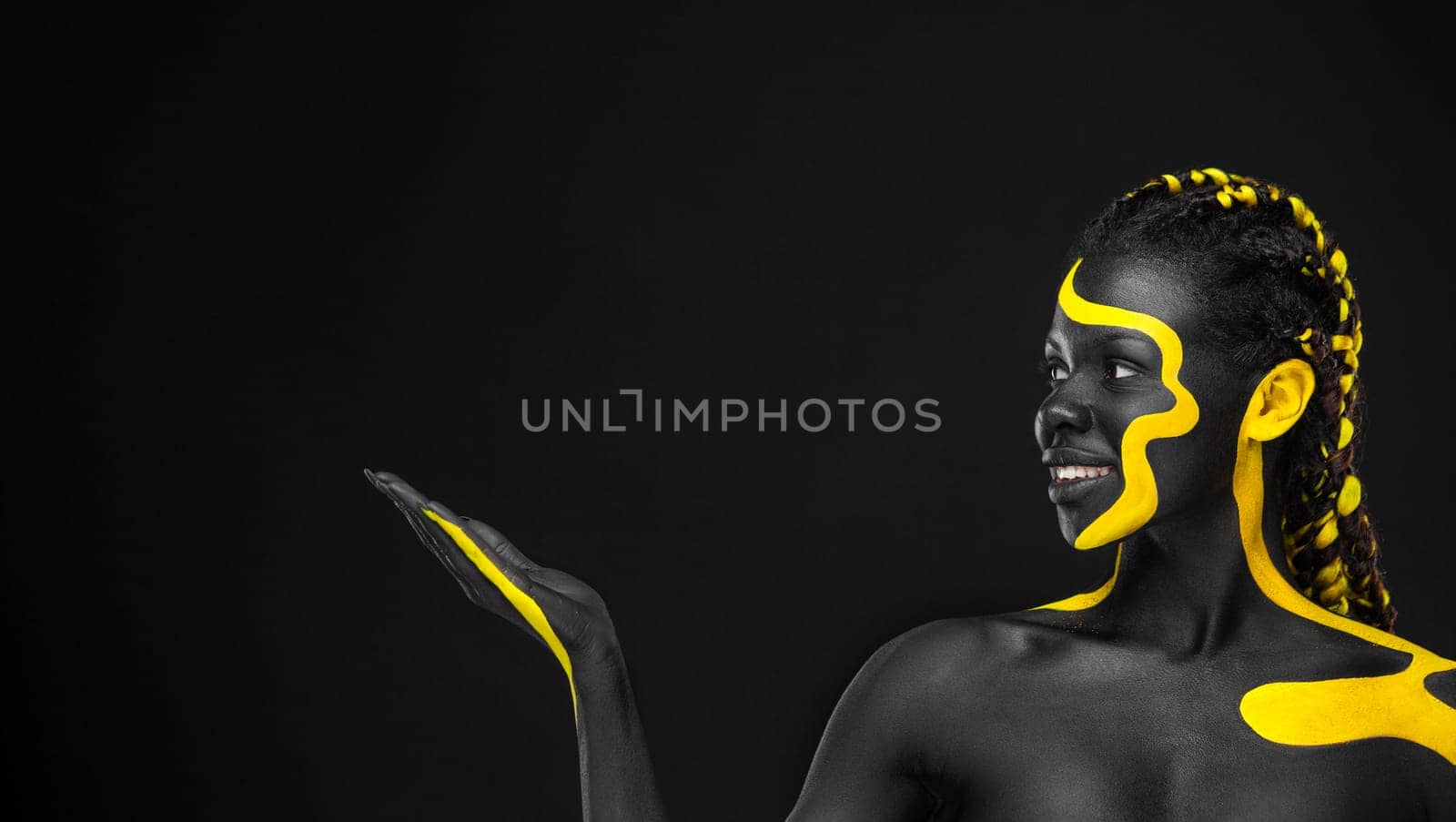 The Art Face. Black and yellow body paint on african woman. Abstract creative portrait. Copy space for your text by MikeOrlov