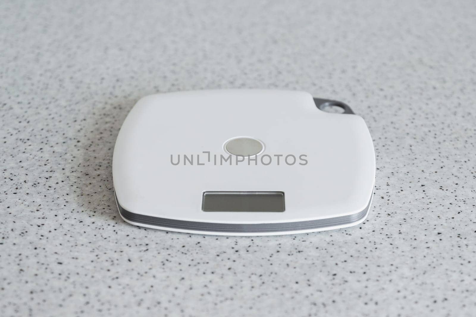 Digital kitchen scale on a kitchen table. Electronic scales for measurement the food weight, copy space.