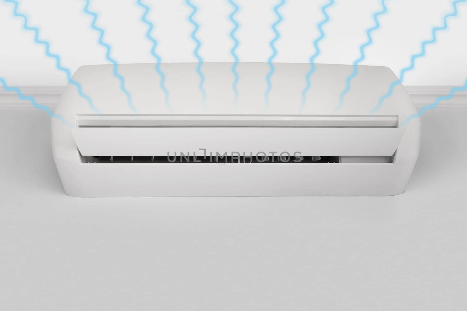 Streams of fresh cool air from a white wall-mounted air conditioner, copy space.
