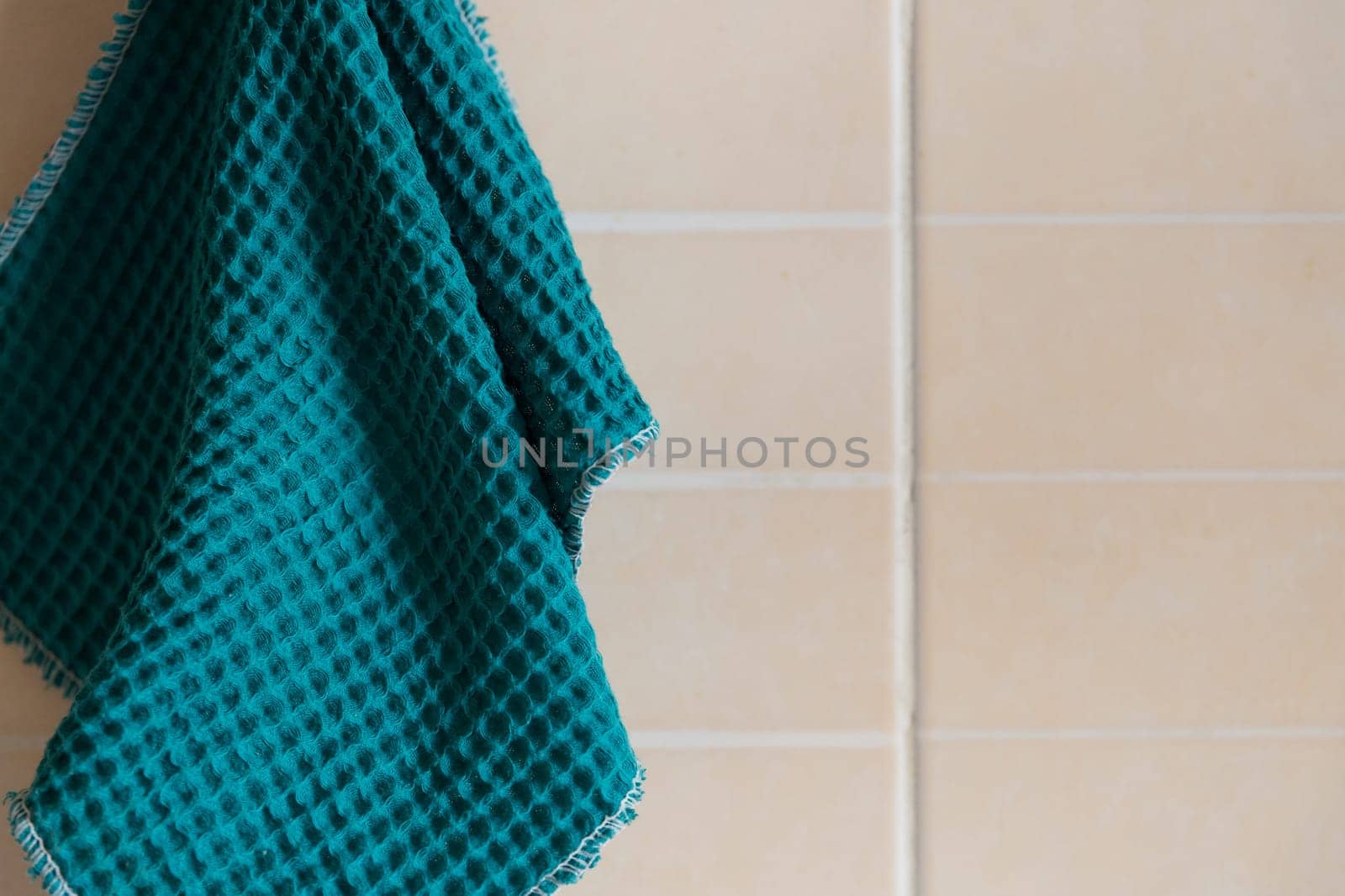 Kitchen blue waffle towel hanging on the wall.