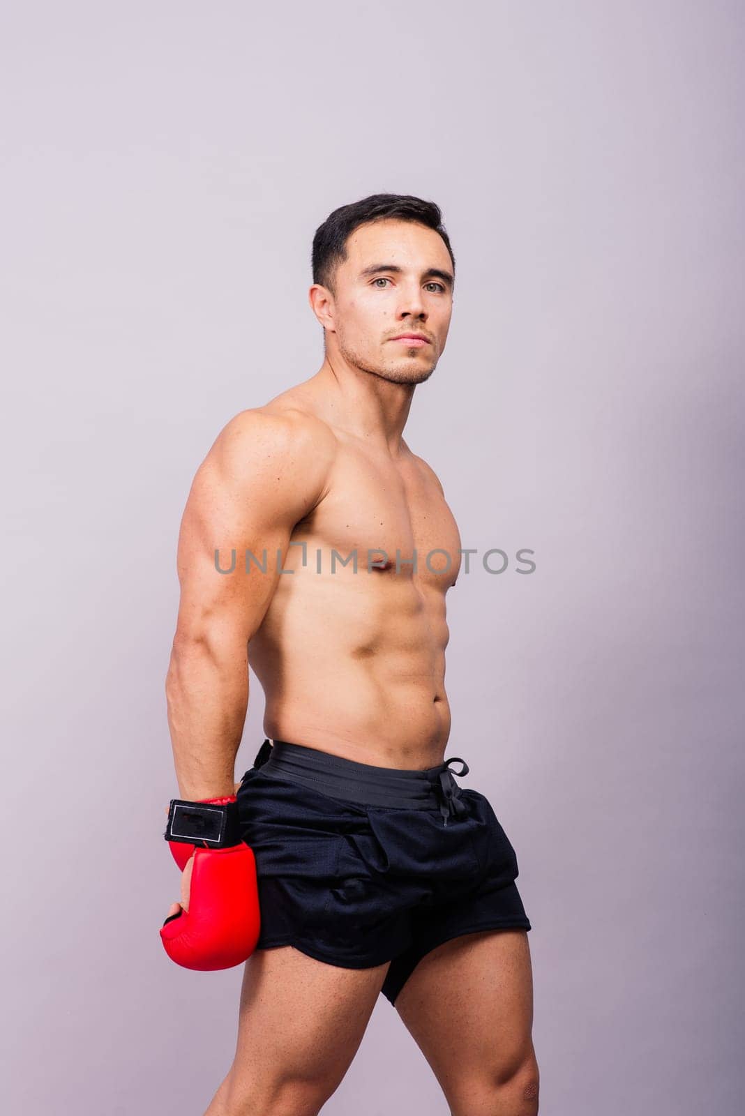 Boxing gloves, man training in a sports fight, challenge or mma competition on studio background.