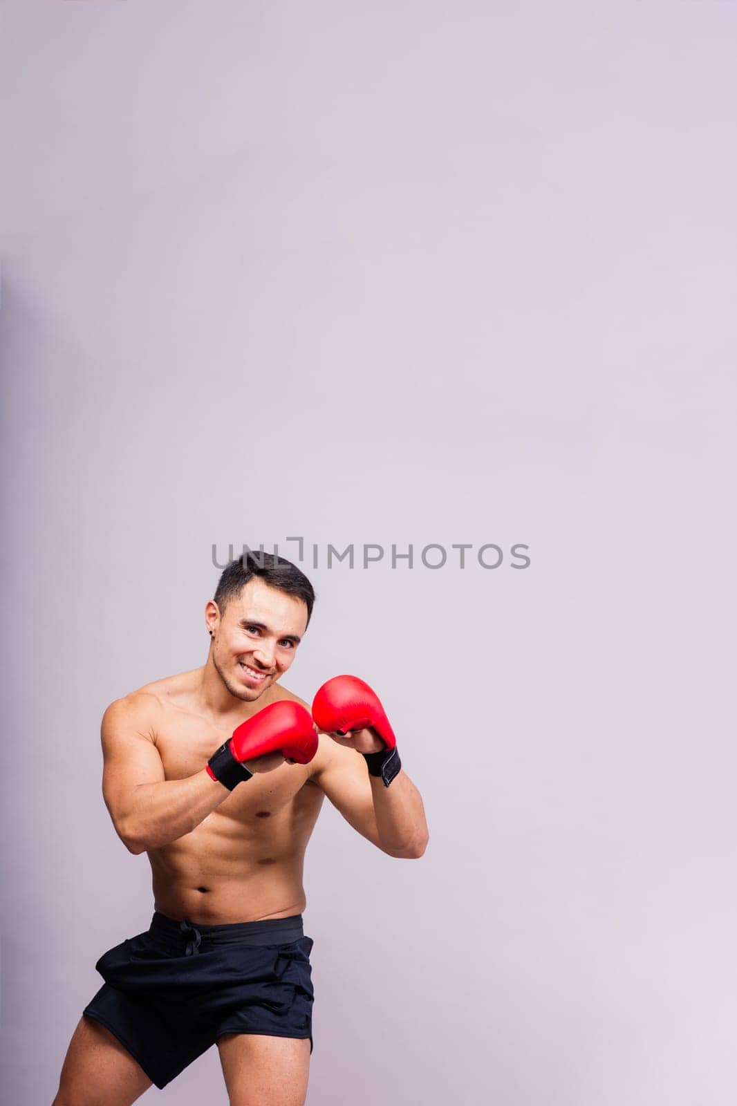 Boxing gloves, man training in a sports fight, challenge or mma competition on studio background.