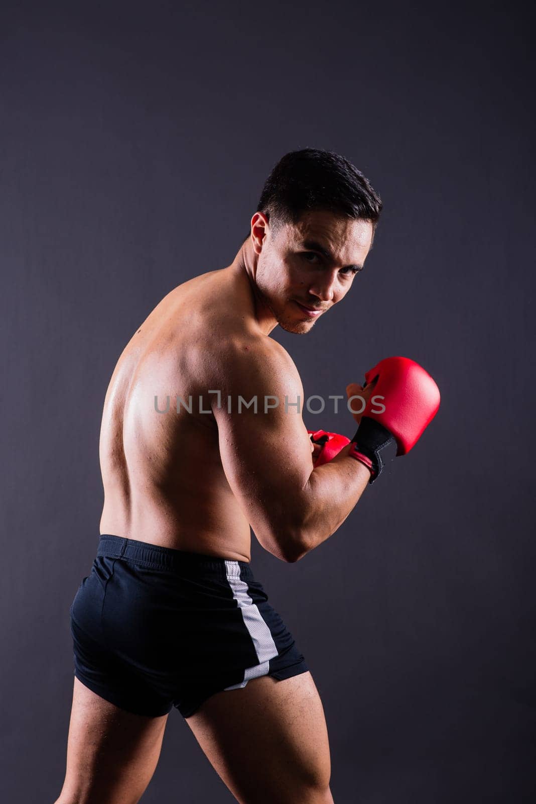 Boxing gloves, man training in sports fight, challenge or mma competition on studio background. by Zelenin