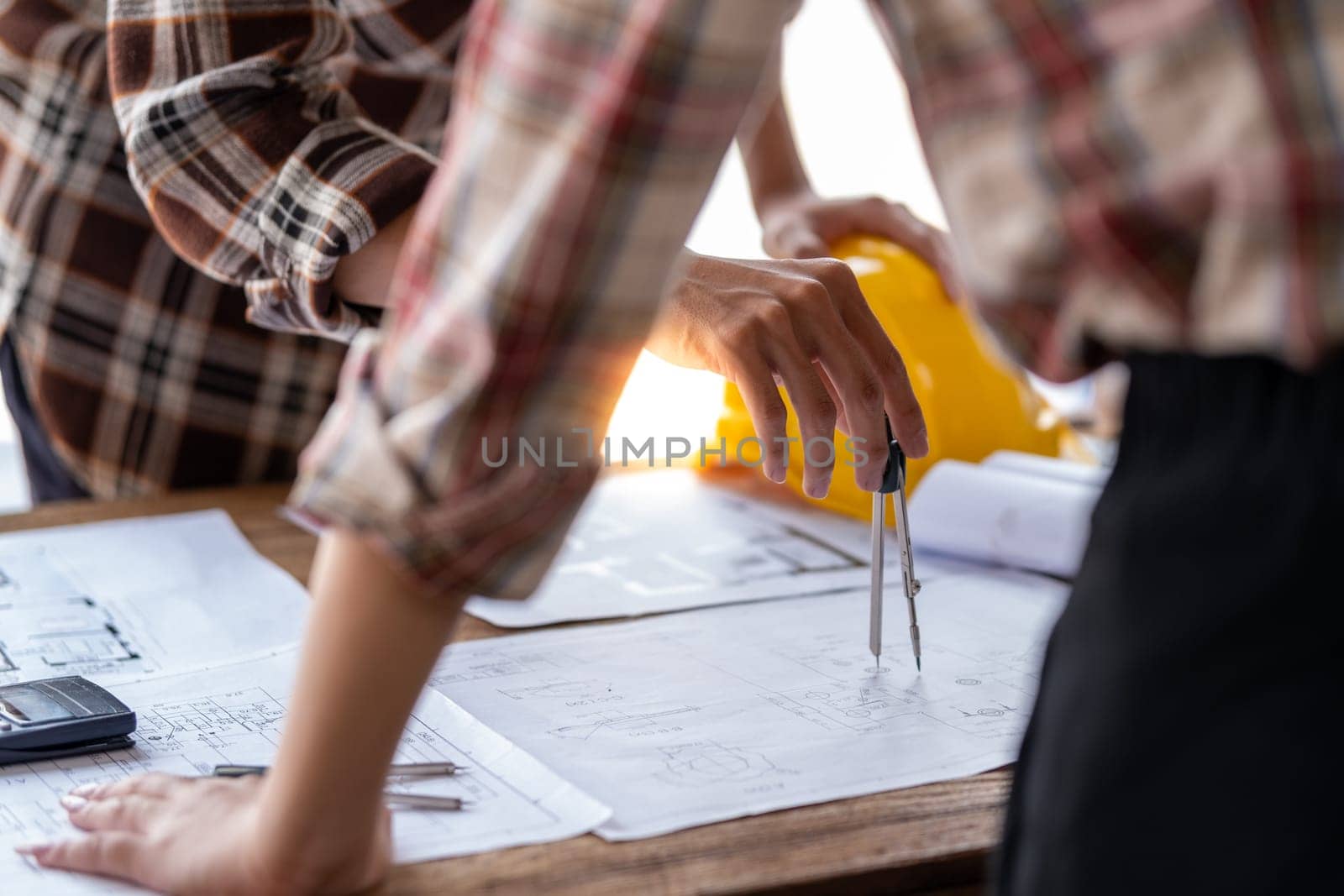 Architect engineer drawing building reconstruction sketch, Engineer design construction, professional engineers discussion and cooperate plan project of house. High quality photo