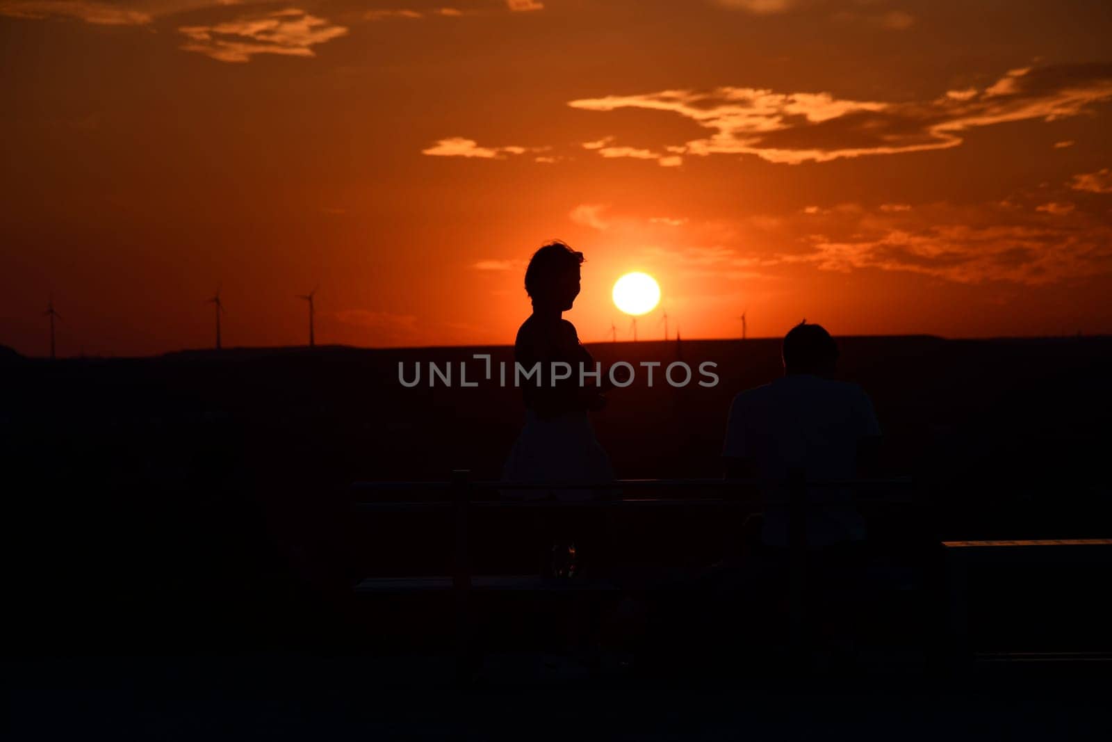 View of outlines of people at the sunset in Bottrop, Germany in Ruhr area