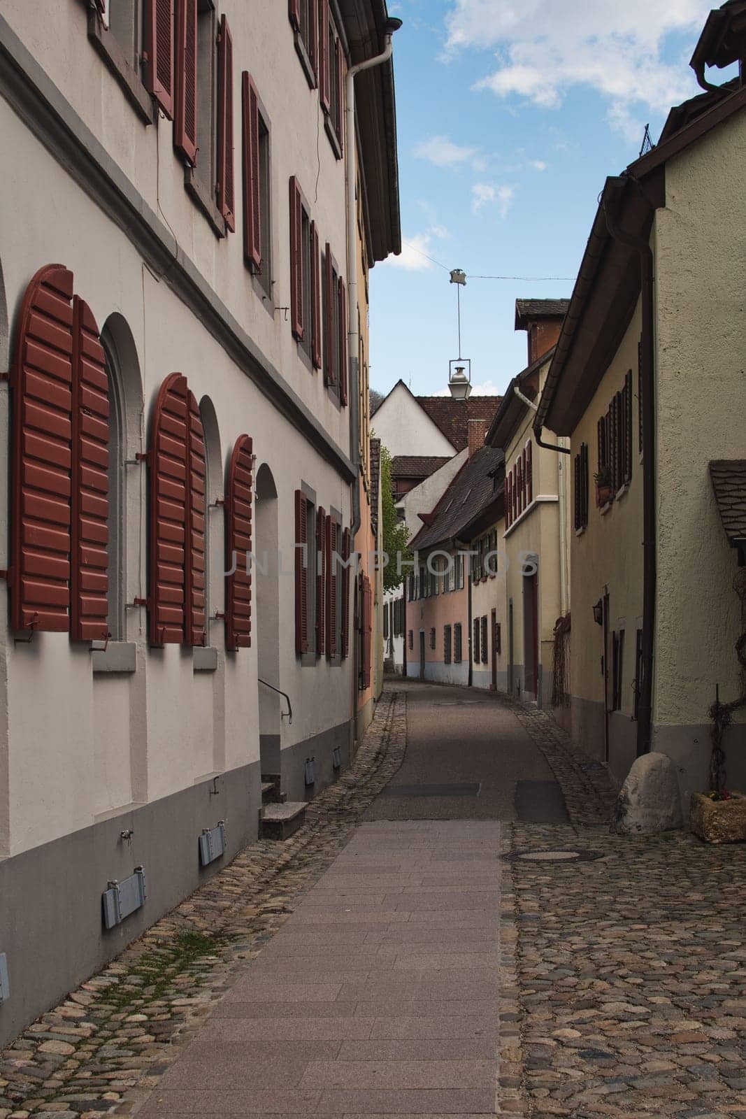Vertical shot of a narrow street in the old town of Staufen im Breisgau, Germany