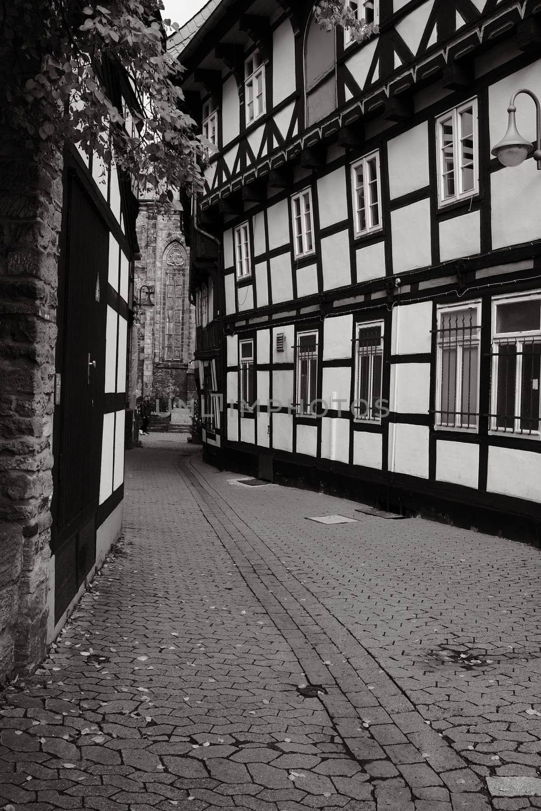 Vertical shot of Marktkirche from the parish courtyard with half-timbered houses in Goslar, Germany