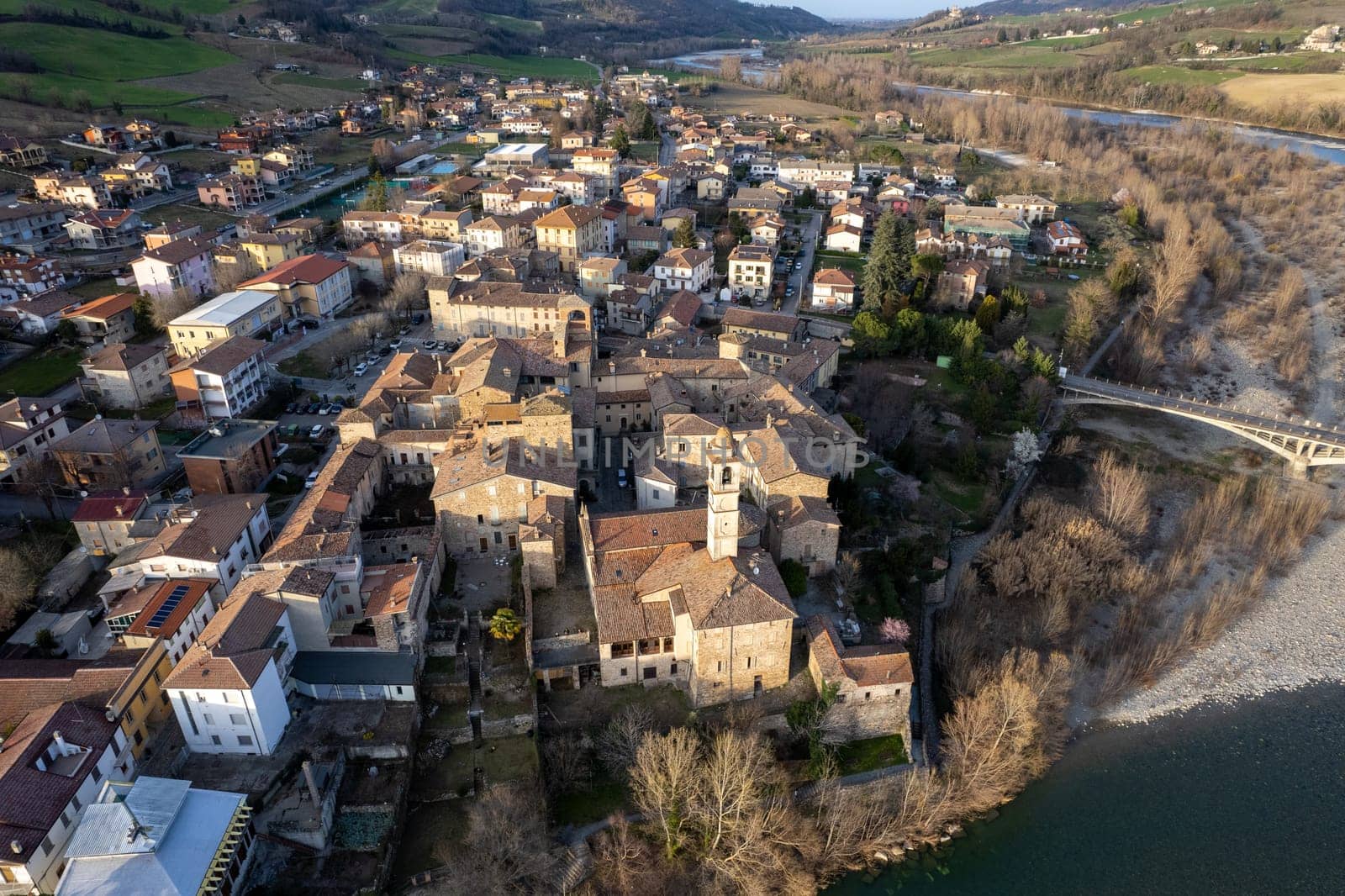 Aerial scenic view of Travo Village, Trebbia river, Valley landscape, Piacenza Italy at sunset