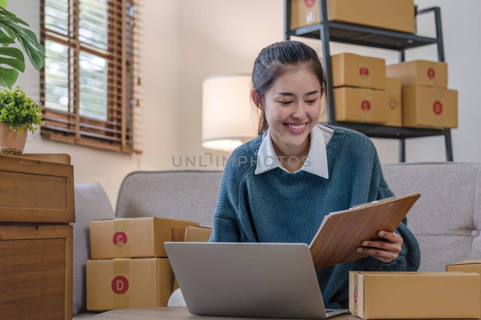 Portrait young attractive asian female owner startup business work happy with box at home prepare parcel delivery in sme supply chain, start up small business concept...