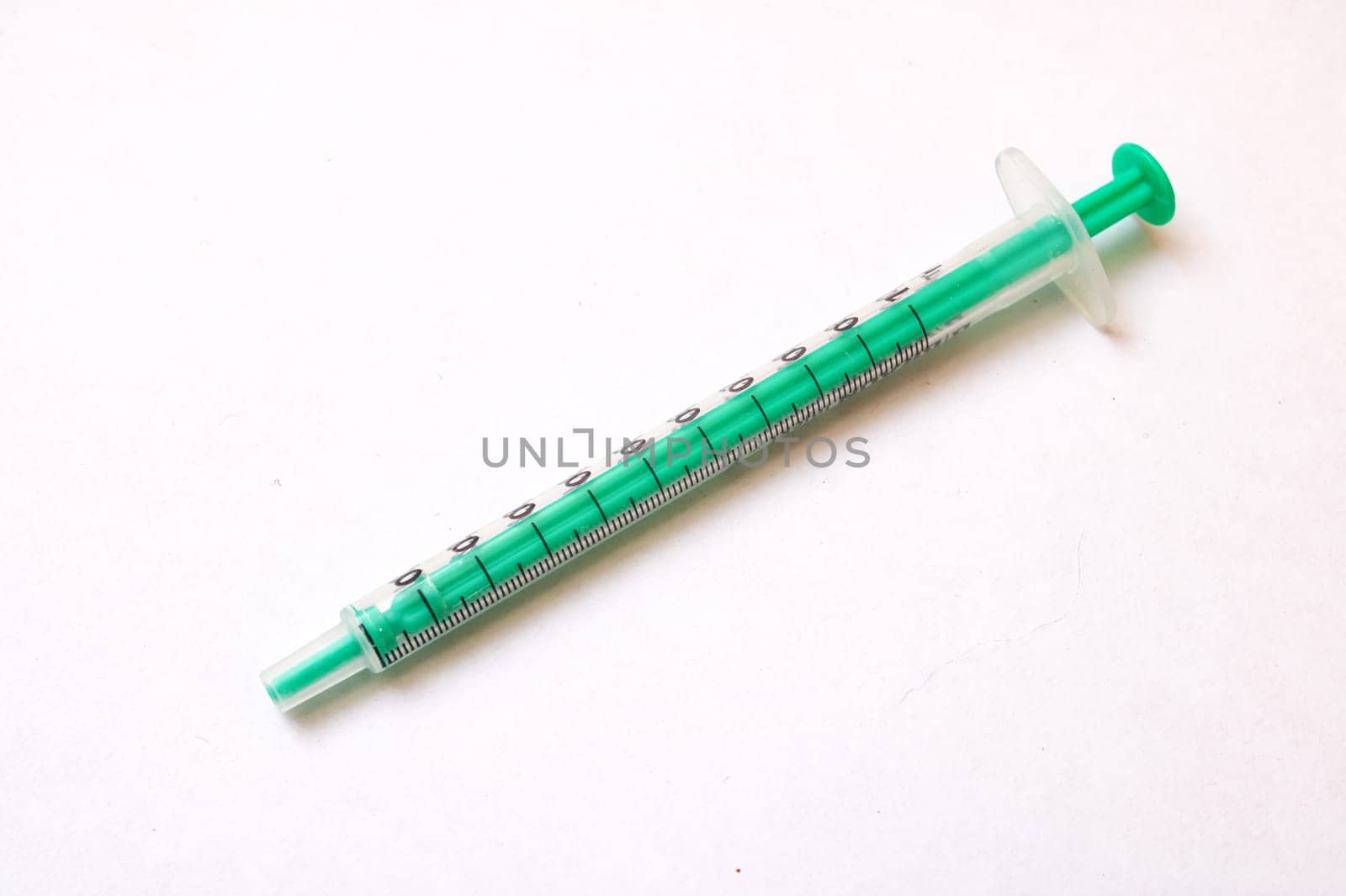Large medical syringe on a gray background close up