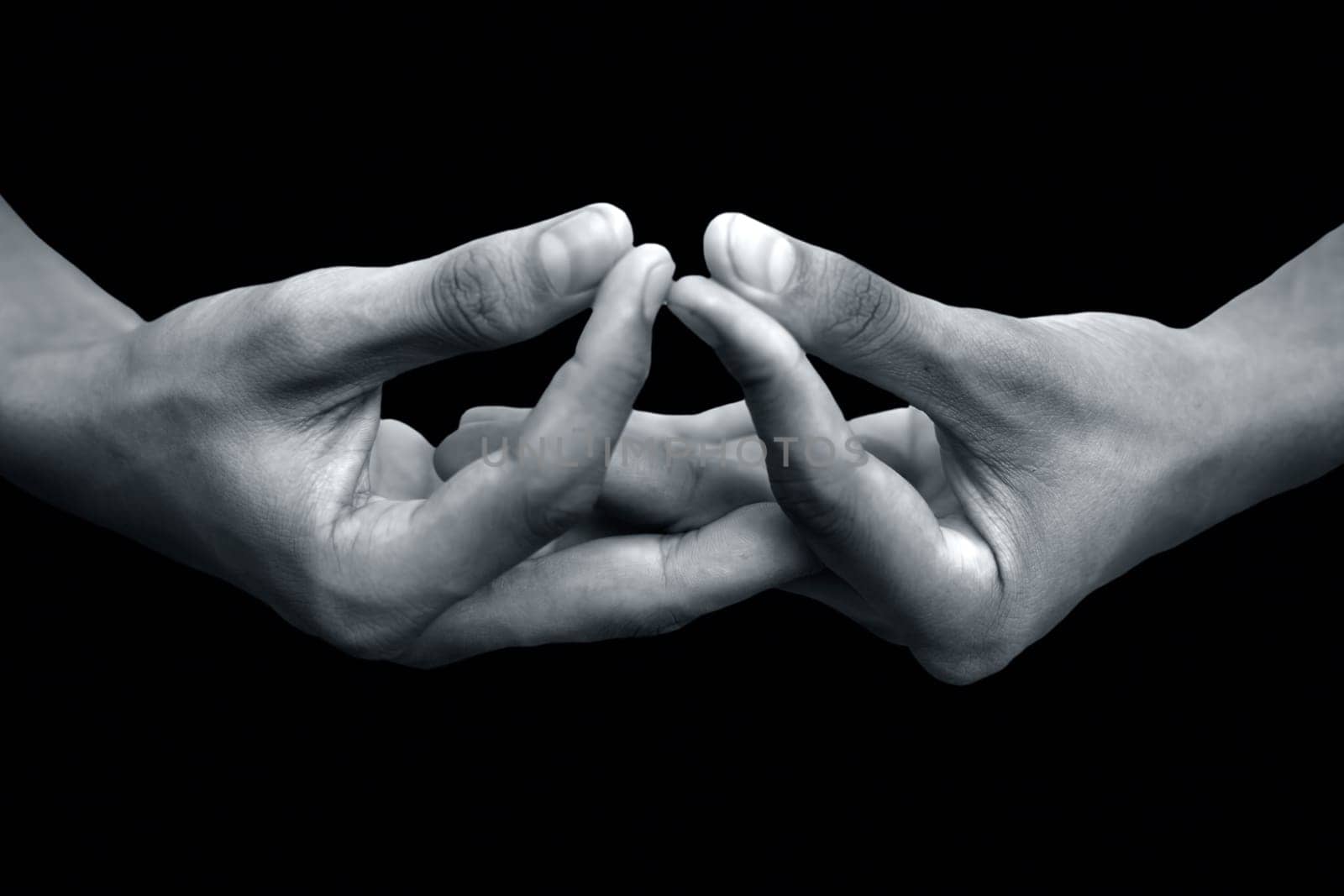 Mida-no Jouin Mudra demonstrated by male hands isolated on black background. by mirzamlk