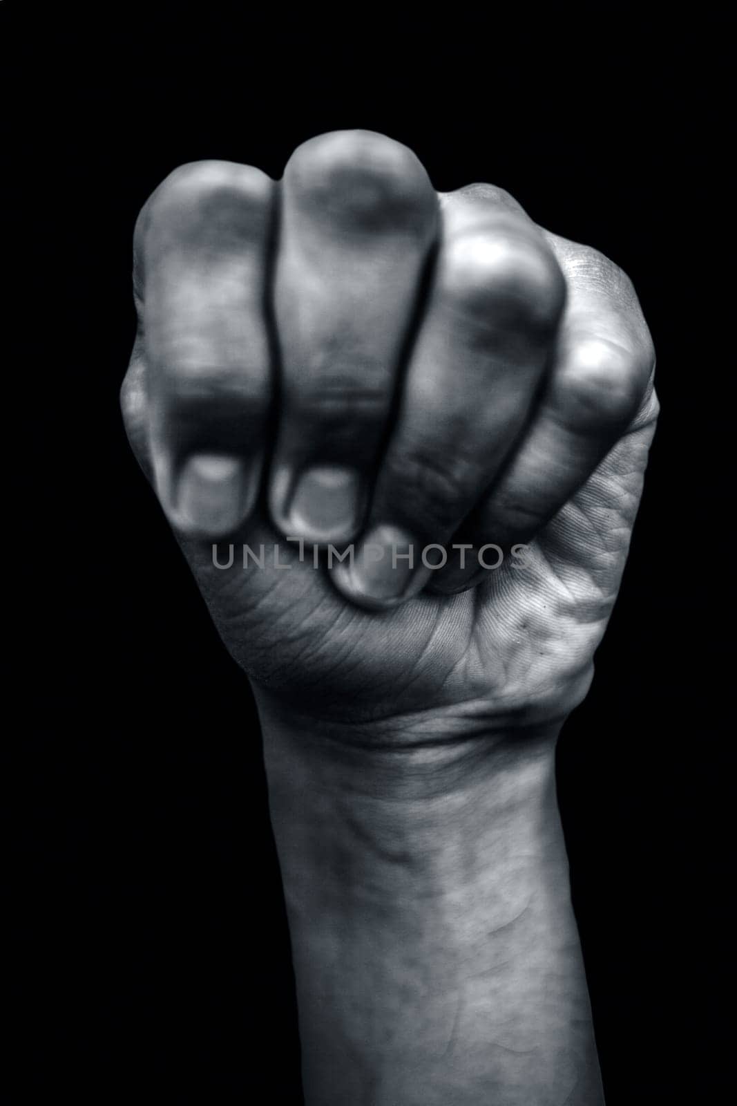 Mushti Yoga Mudra demonstrated by a single male hand isolated against a black background. by mirzamlk