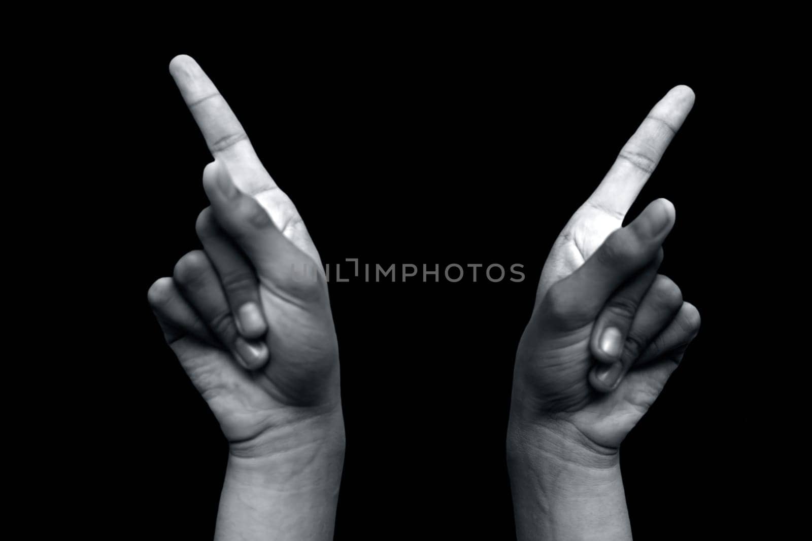 Shot of hands demonstrating Suchi Mudra isolated on black background.