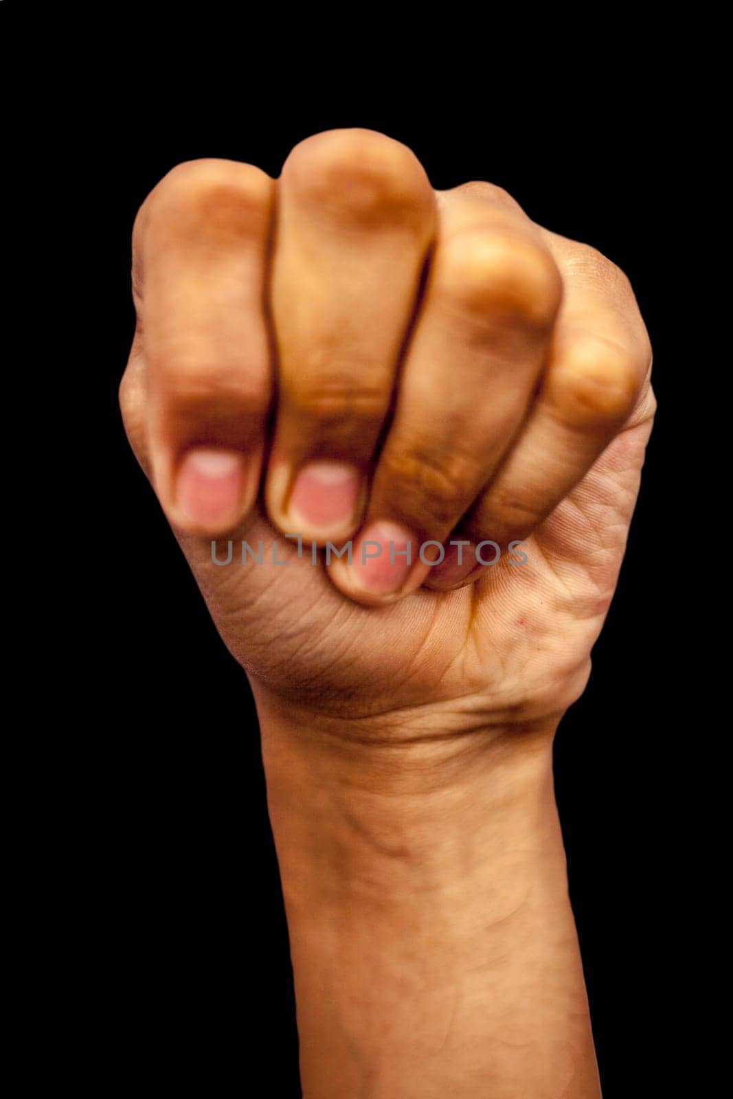 Mushti Yoga Mudra is demonstrated by a single male hand isolated against a black background.