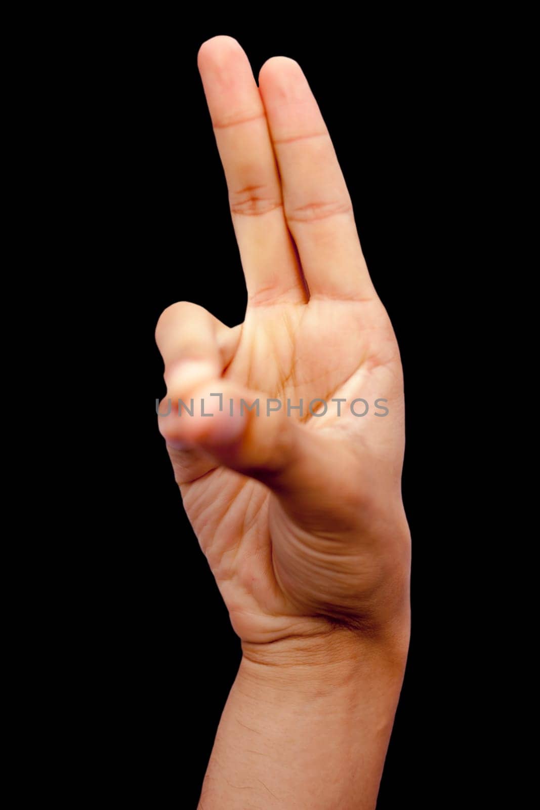 Shot of a human hand showing prana mudra isolated on black background. by mirzamlk