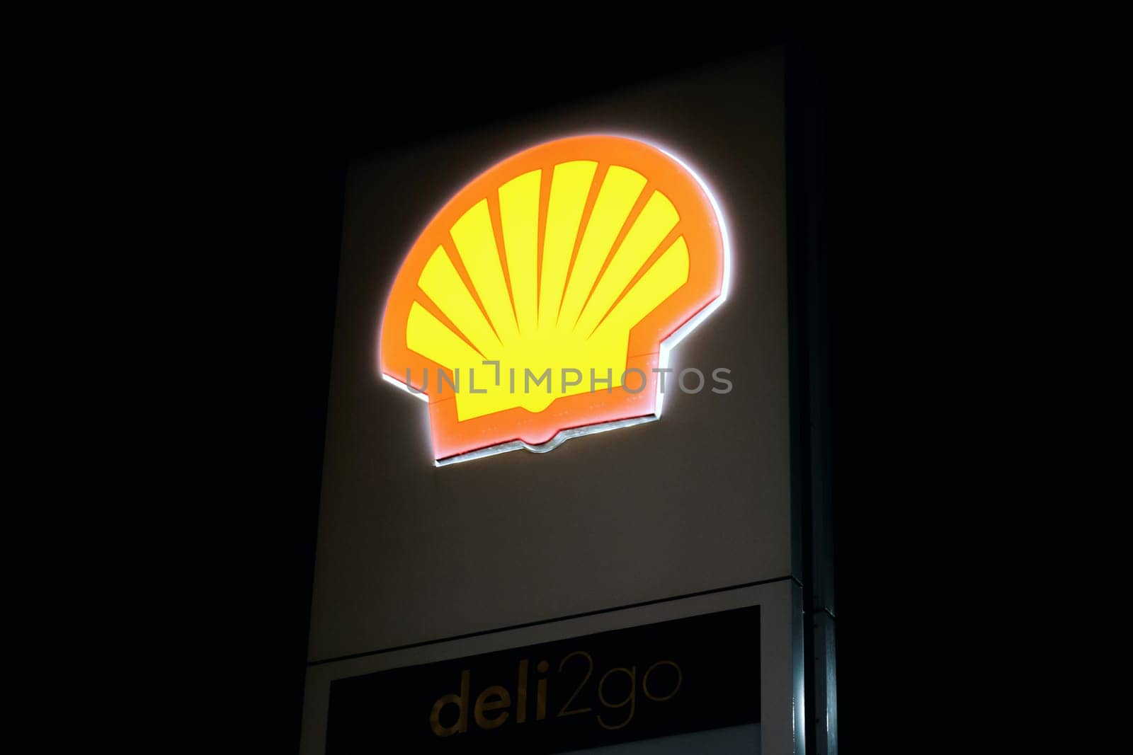 Ryazan, Russia - March 11, 2023: Glowing Shell company logo against the black night sky