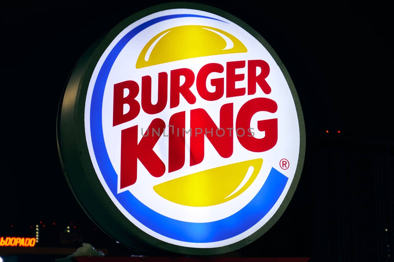 Ryazan, Russia - March 11, 2023: Glowing at night Burger King logo close-up