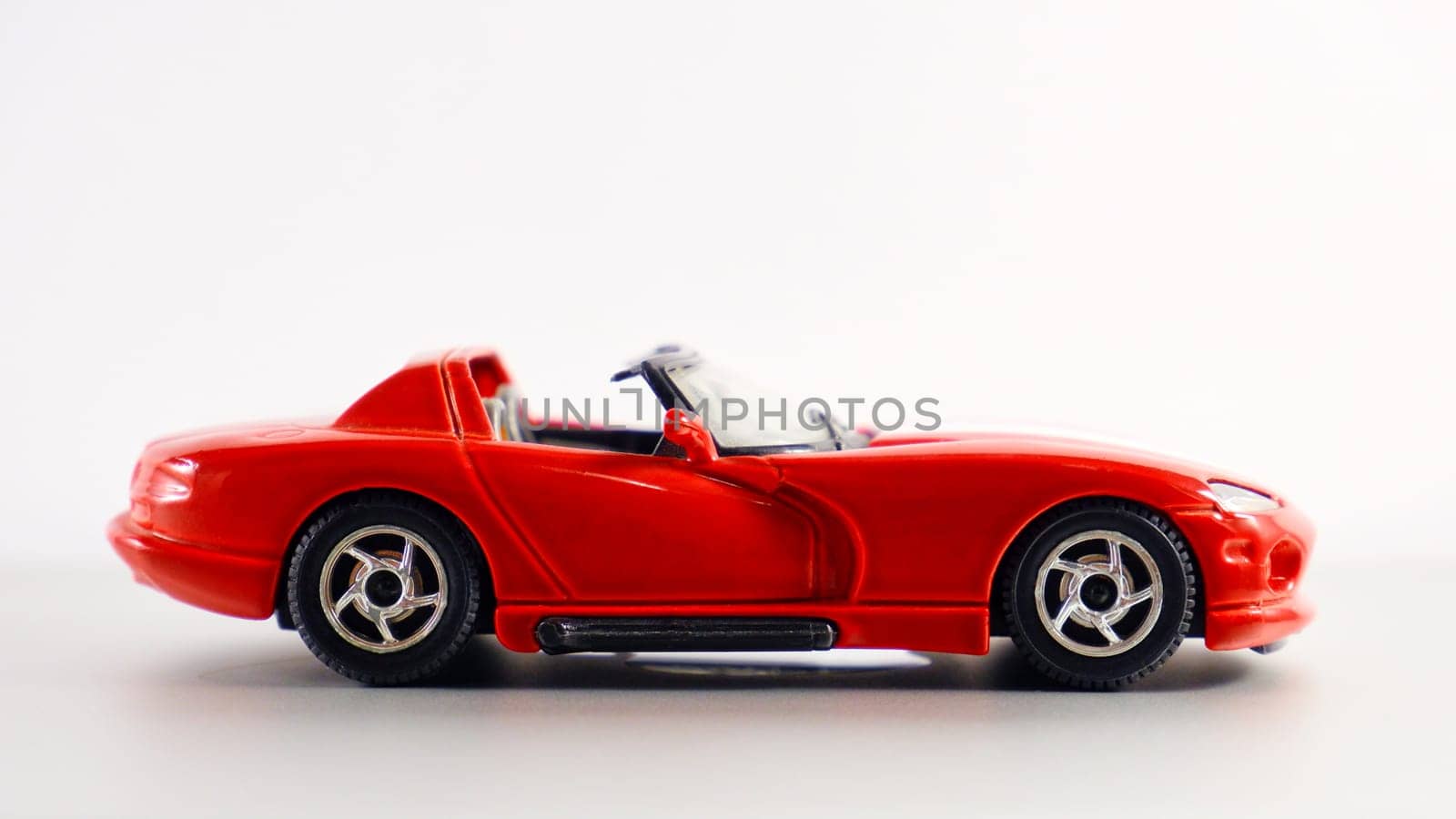 Ryazan, Russia - August 28 2022: Scale model of a red Dodge Viper car on a white background