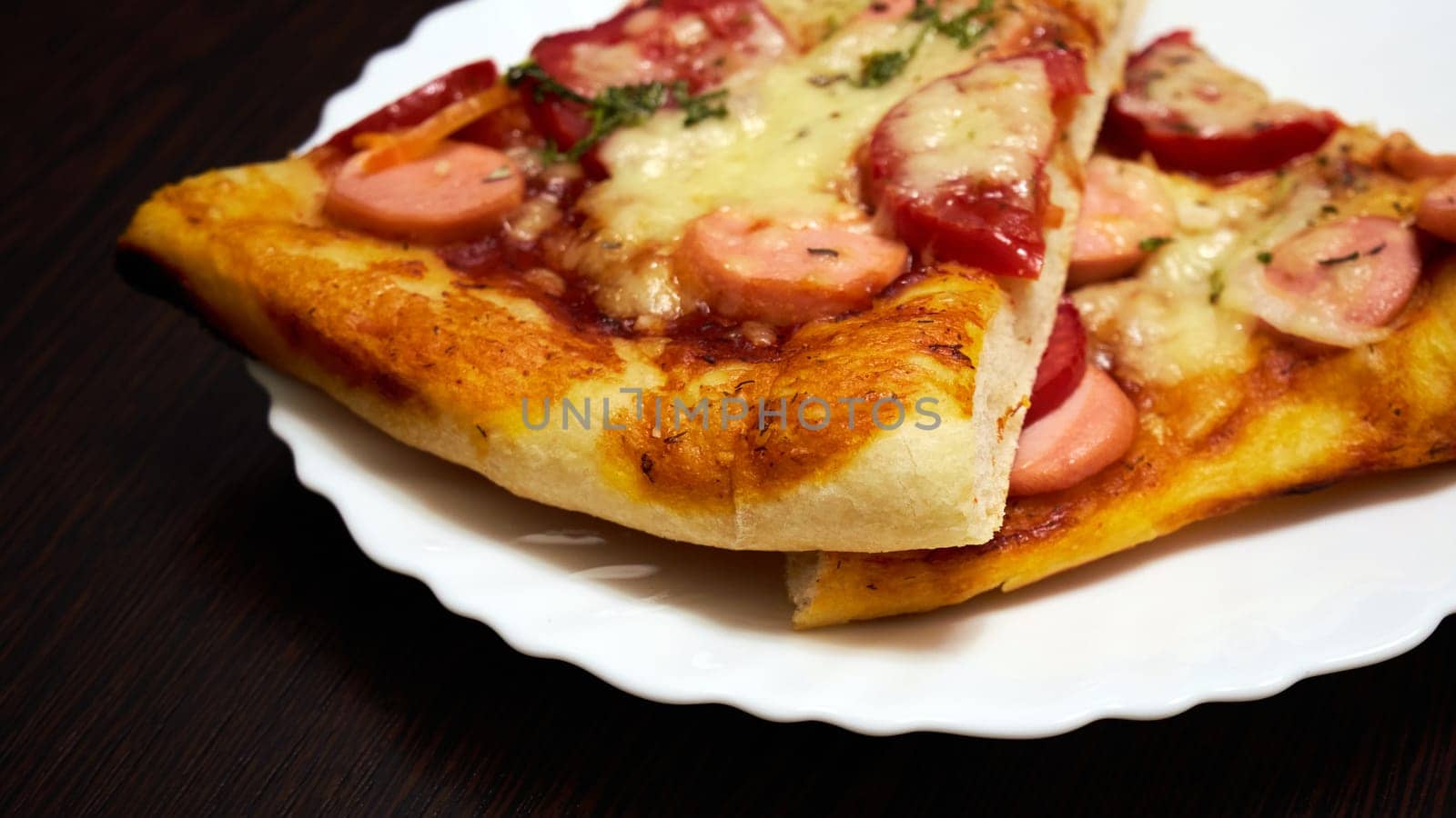 Pizza slice on white plate side view