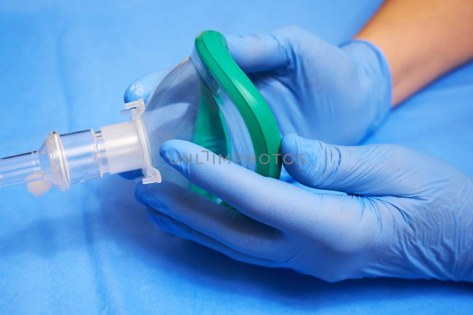 Anesthesia mask. Hands of a medic in gloves and an anesthesia mask