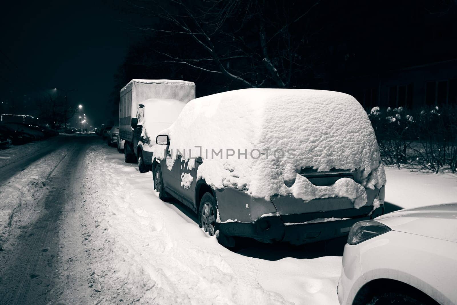 Cars covered with snow on a city street